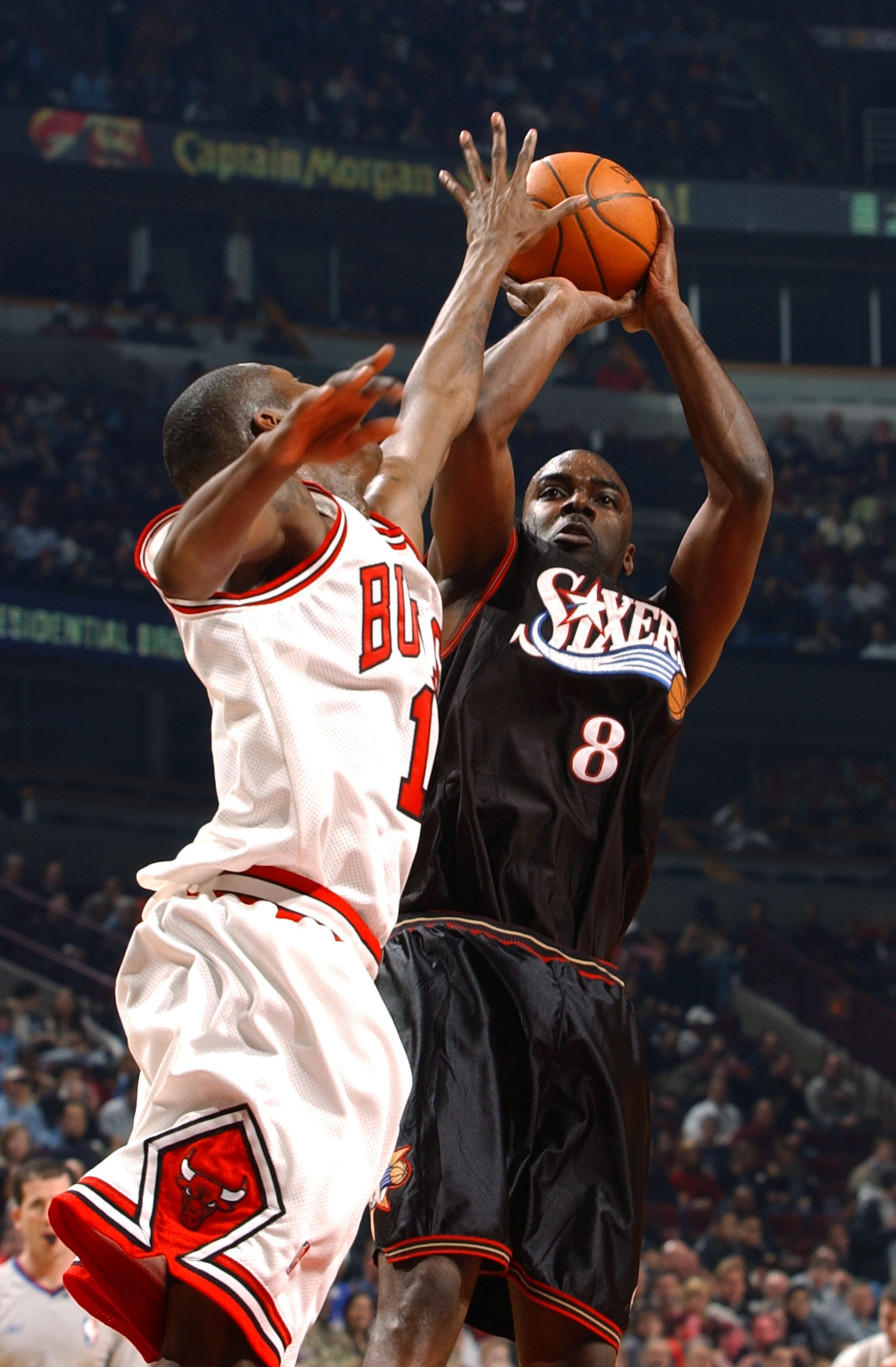 CHICAGO - MARCH 9:  Guard Aaron McKie #8 of the Philadelphia 76ers shoots over guard Jamal Crawford #1 of the Chicago Bulls during a game on March 9, 2004 at the United Center in Chicago, Illinois. The 76ers defeated the Bulls 89-81. NOTE TO USER: User ex