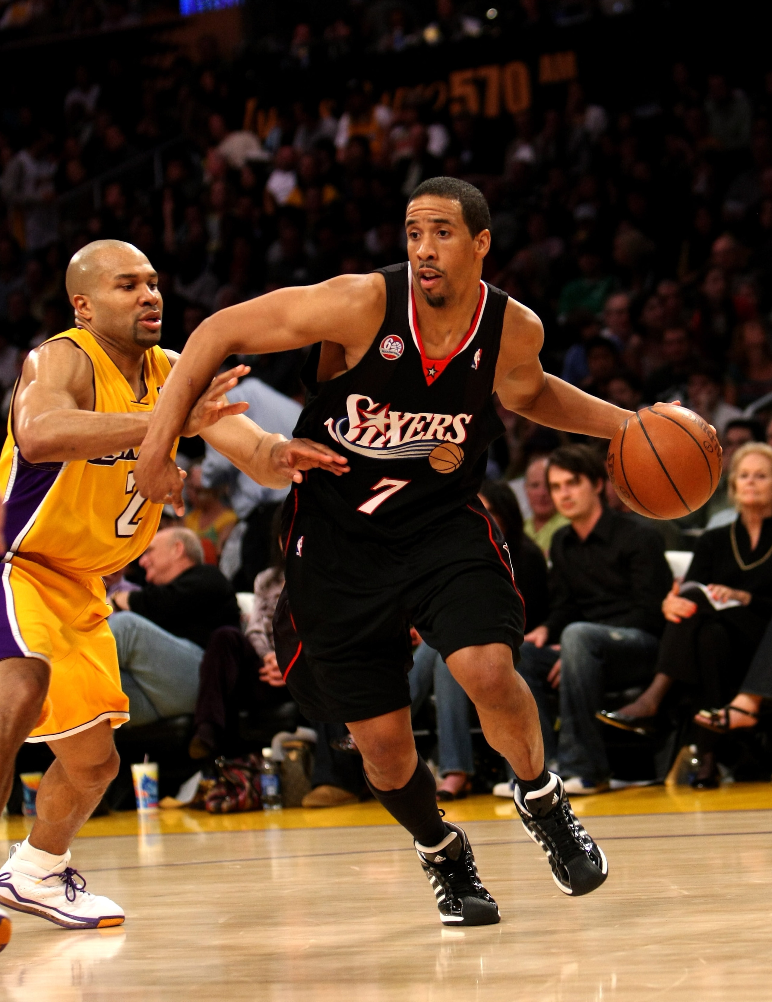 LOS ANGELES - MARCH 17:   Andre Miller #7 of the Philadelphia 76ers drives around Derek Fisher #3 of the Los Angeles Lakers on March 17, 2009 at Staples Center in Los Angeles, California.  The 76ers won 94-93.   NOTE TO USER: User expressly acknowledges a