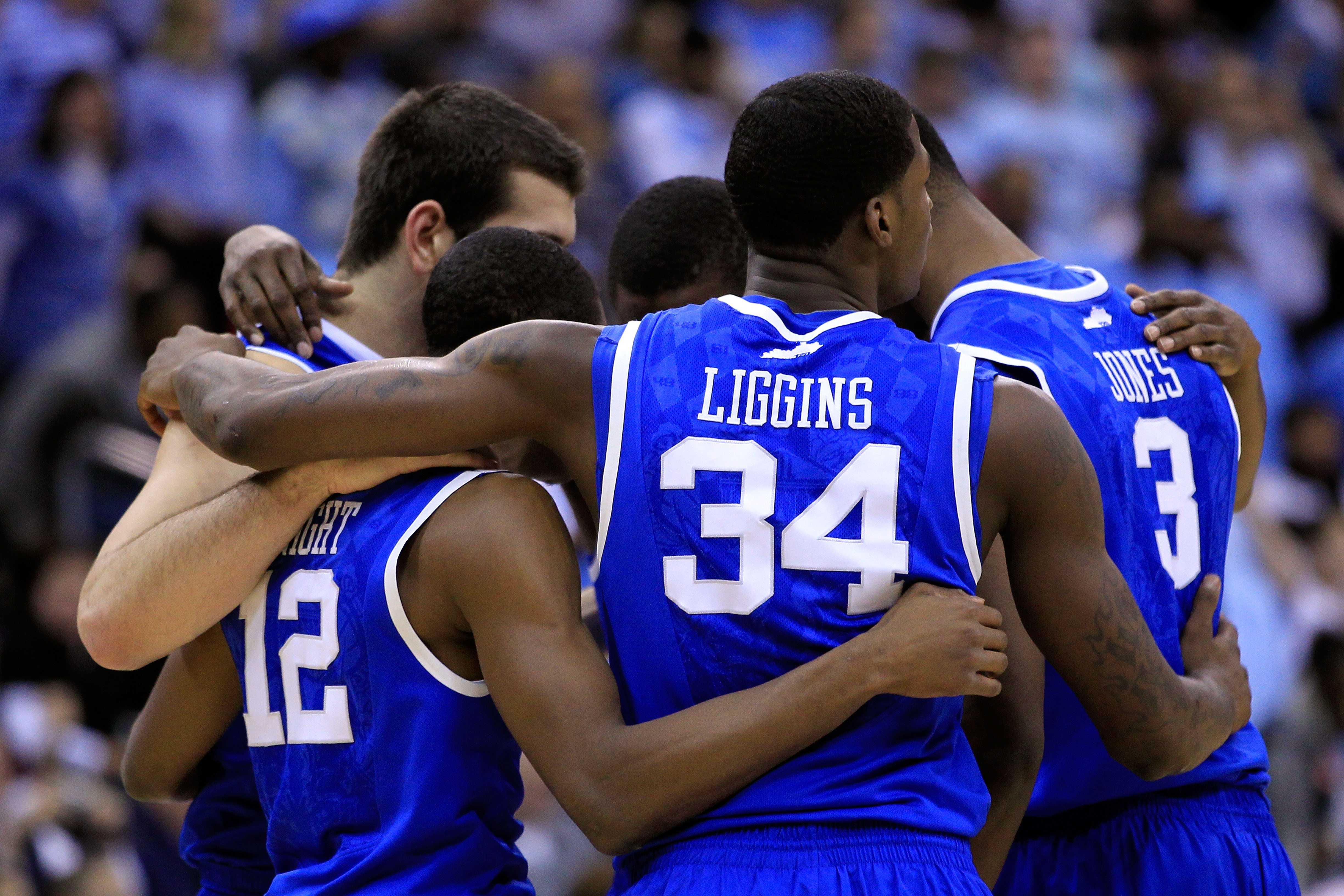 NEWARK, NJ - MARCH 27:  DeAndre Liggins #34 of the Kentucky Wildcats hugs teammates Brandon Knight #12 and Terrence Jones #3 during their game against the North Carolina Tar Heels in the east regional final of the 2011 NCAA men's basketball tournament at