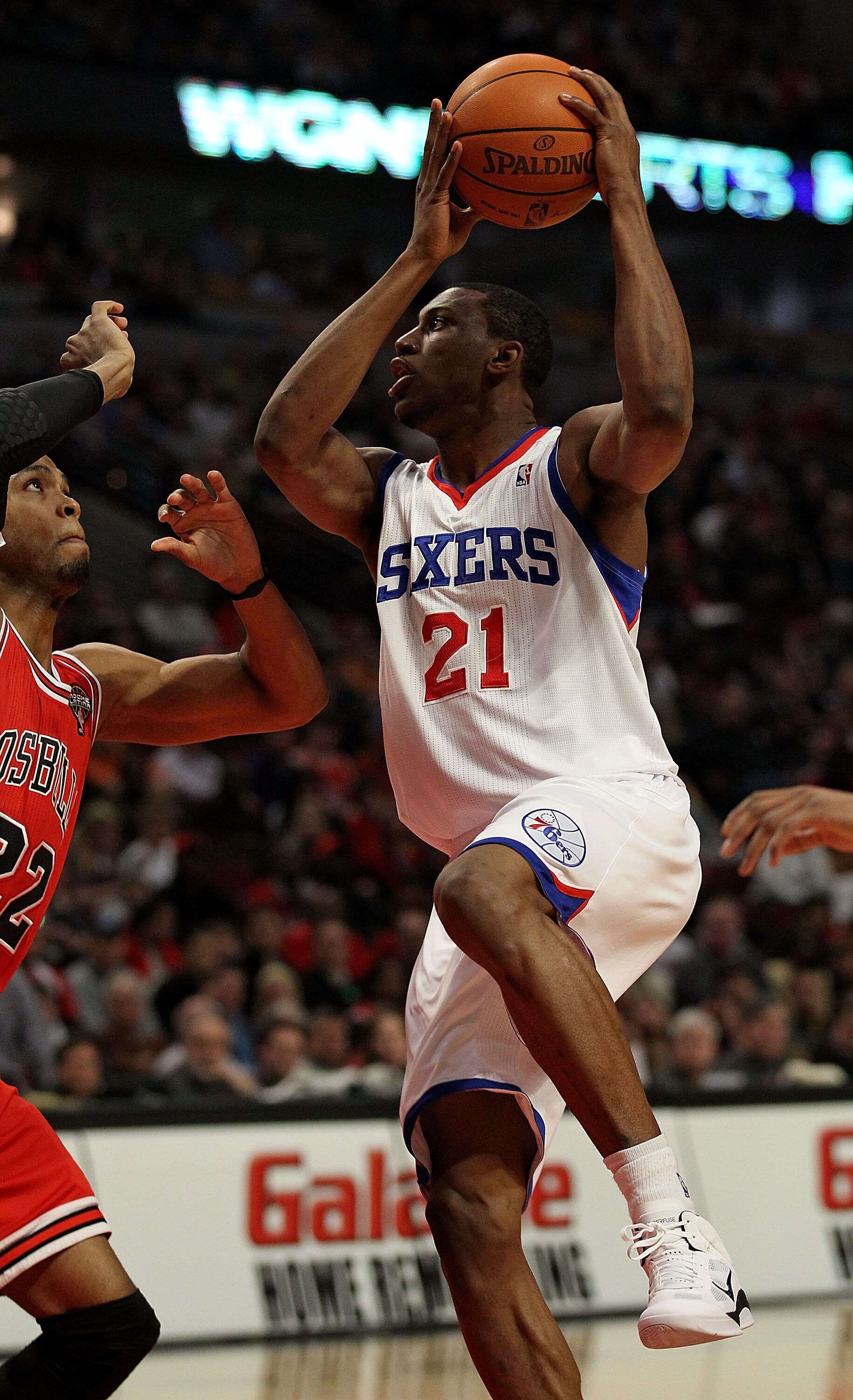CHICAGO, IL - MARCH 28: Thaddeus Young #21 of the Philadelphia 76ers puts up for a shot against Taj Gibson #22 of the Chicago Bulls at the United Center on March 28, 2011 in Chicago, Illinois. NOTE TO USER: User expressly acknowledges and agrees that, by