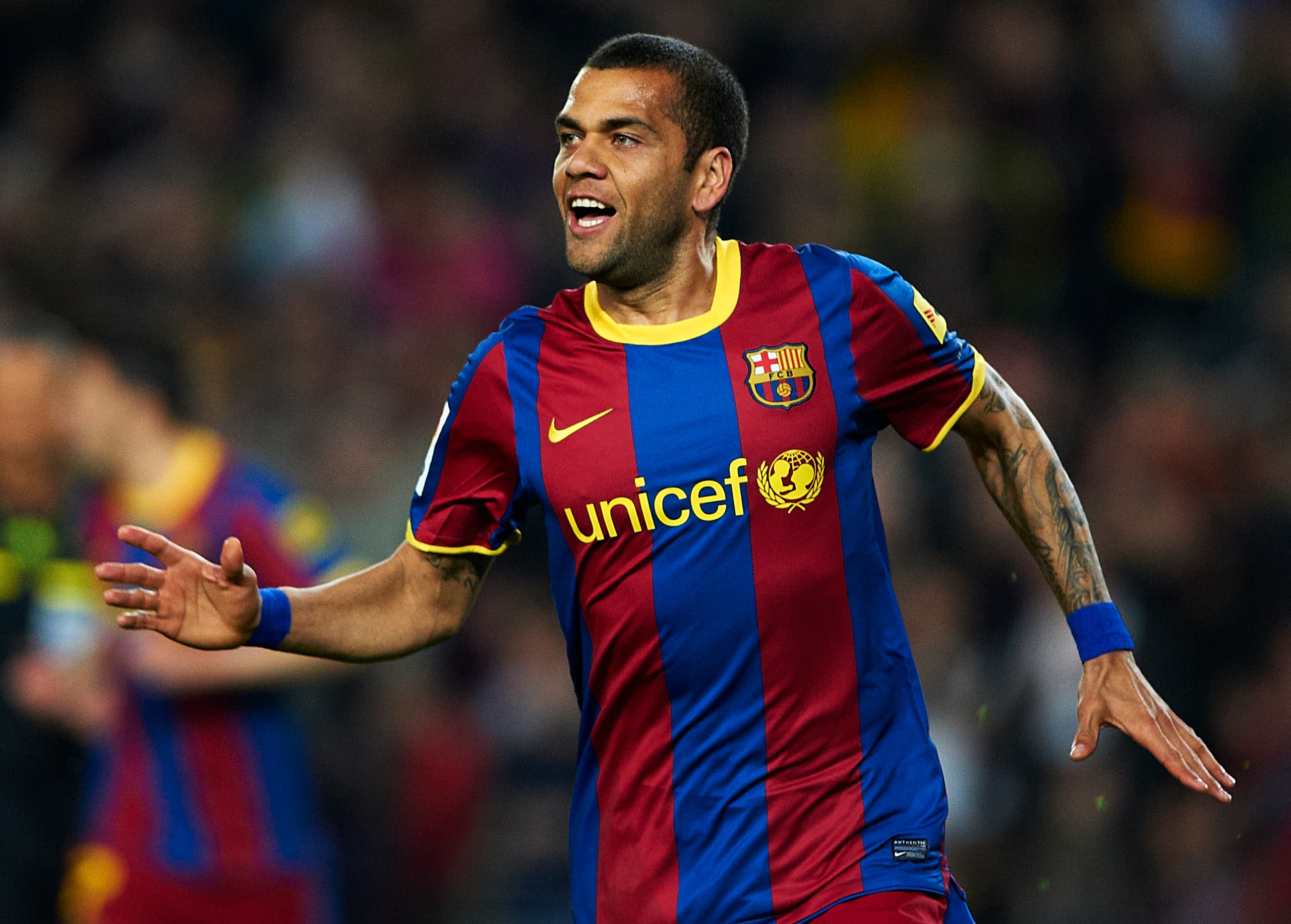 BARCELONA, SPAIN - MARCH 19:  Daniel Alves of Barcelona celebrates after scoring during the La Liga match between Barcelona and Getafe at Camp Nou on March 19, 2011 in Barcelona, Spain. Barcelona won 2-1. (Photo by Manuel Queimadelos Alonso/Getty Images)