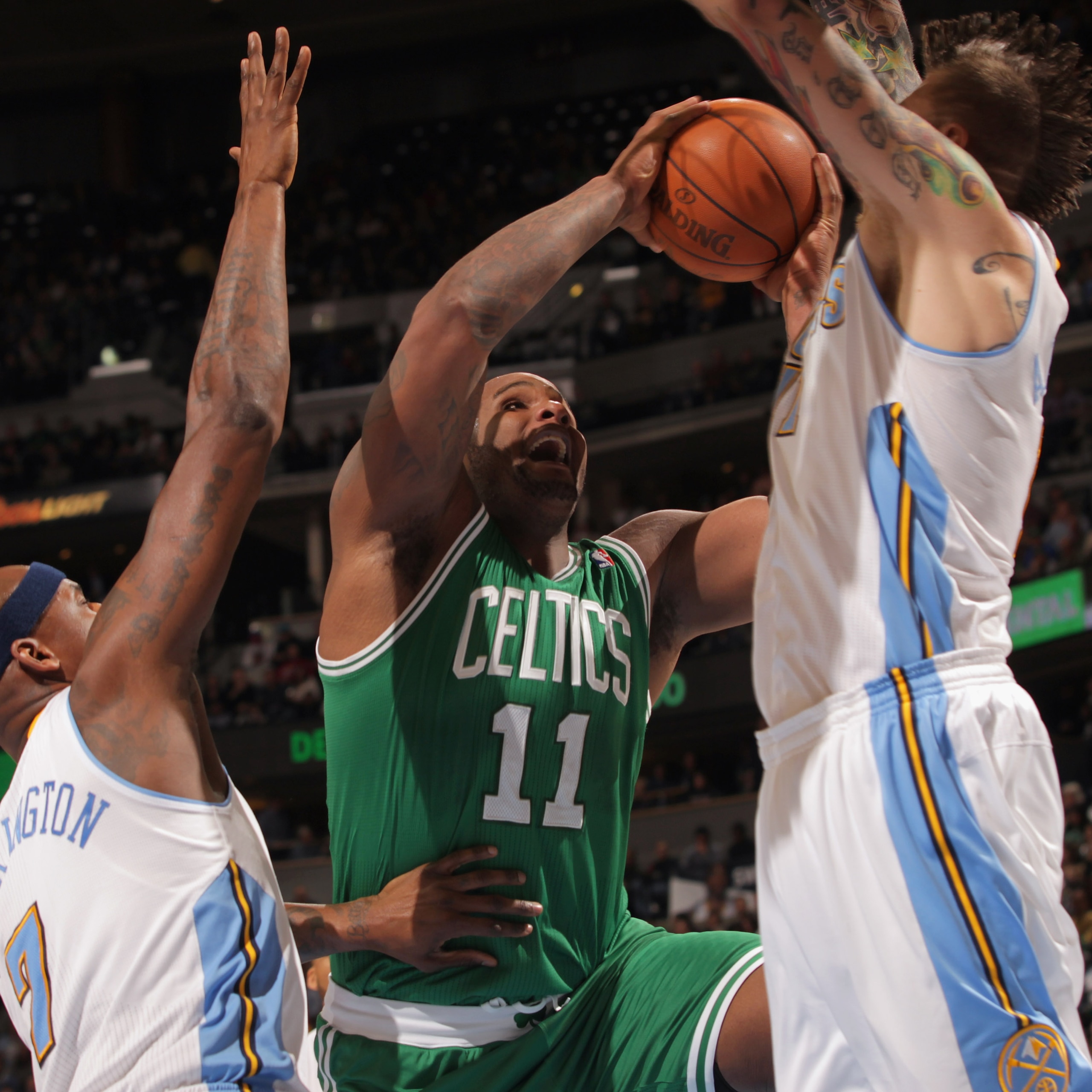 DENVER, CO - FEBRUARY 24:  Glen Davis #11 of the Boston Celtics takes a shot against Al Harrington #7 and Chris Andersen #11 of the Denver Nuggets during NBA action at the Pepsi Center on February 24, 2011 in Denver, Colorado. NOTE TO USER: User expressly
