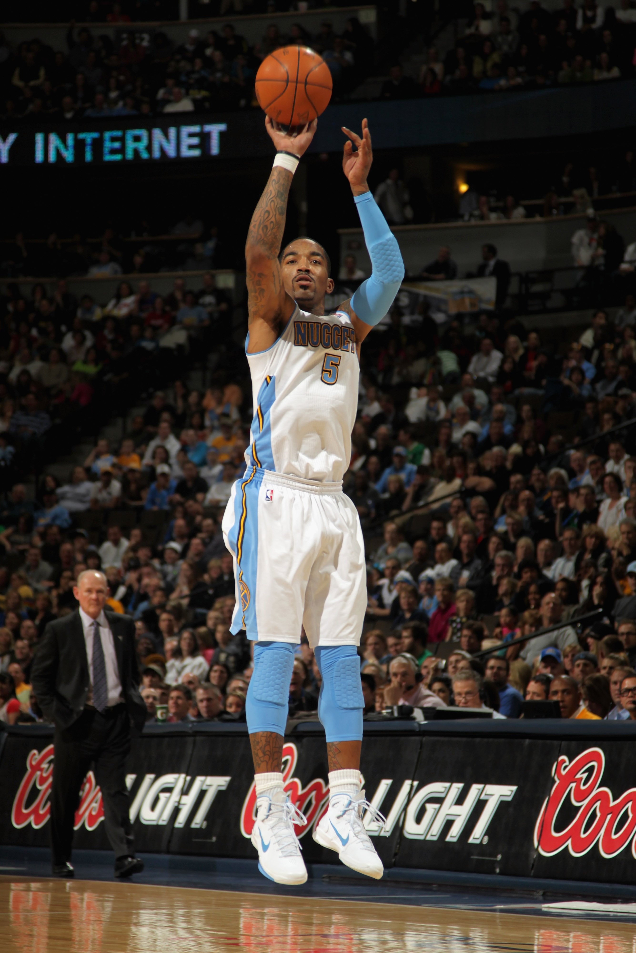 DENVER, CO - MARCH 12:  J.R. Smith #5 of the Denver Nuggets takes a three point shot as he had a game high 31 points agianst the Detroit Pistons as he goes to the basket at the Pepsi Center on March 12, 2011 in Denver, Colorado. The Nuggets defeated the P