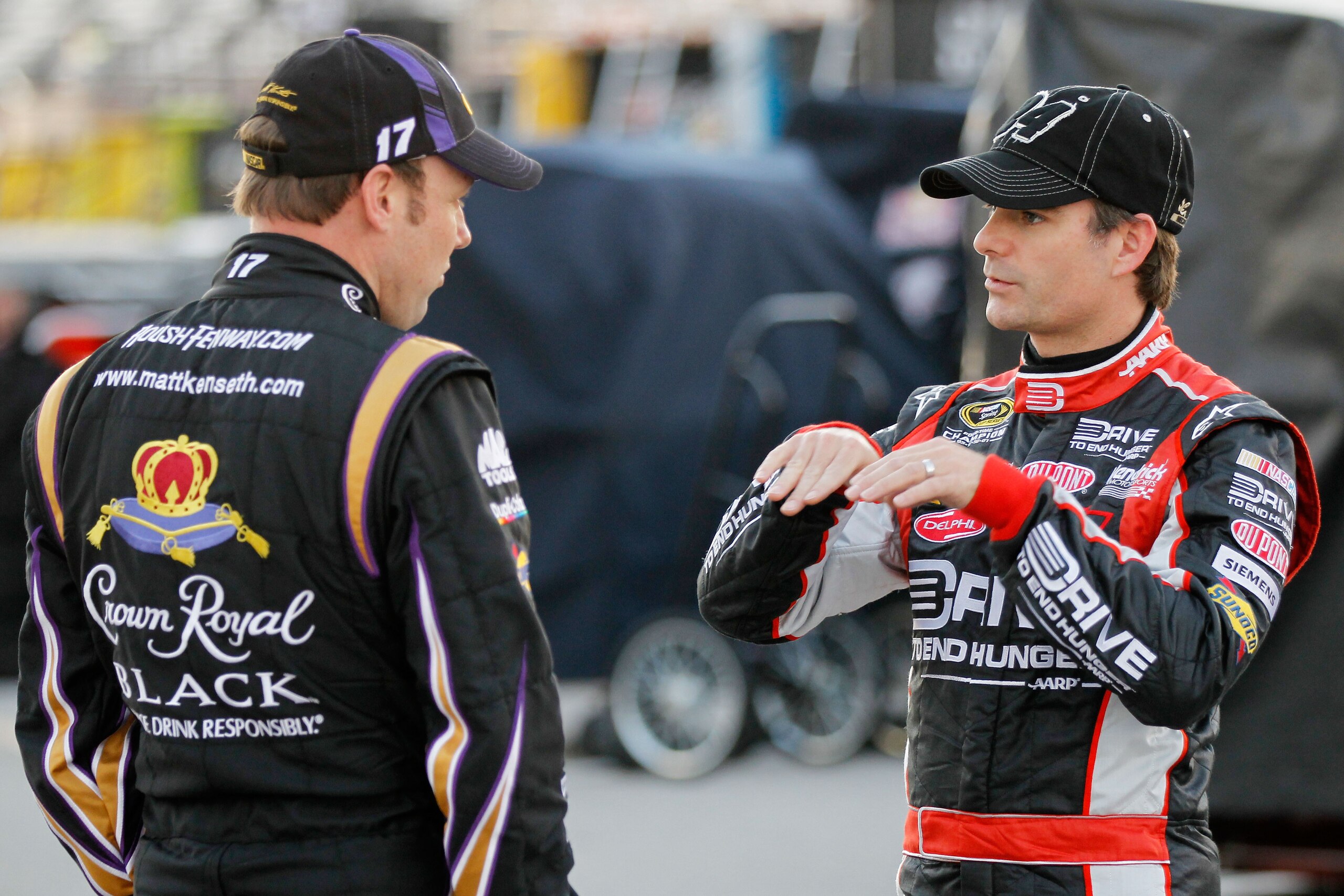 DAYTONA BEACH, FL - FEBRUARY 11:  Jeff Gordon, driver of the #24 Drive to End Hunger Chevrolet, and Matt Kenseth, driver of the #17 Crown Royal Ford, speak during practice for the NASCAR Budweiser Shootout at Daytona International Speedway on February 11,