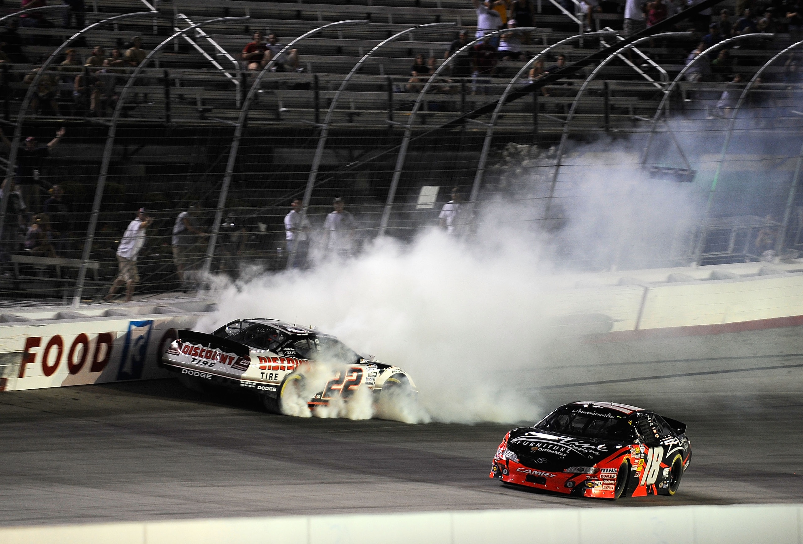 BRISTOL, TN - AUGUST 20:  Brad Keselowski, driver of the #22 Discount Tire Dodge, spins out after an incident with Kyle Busch, driver of the #18 Z-Line Designs Toyota, during the NASCAR Nationwide Series Food City 250 at Bristol Motor Speedway on August 2