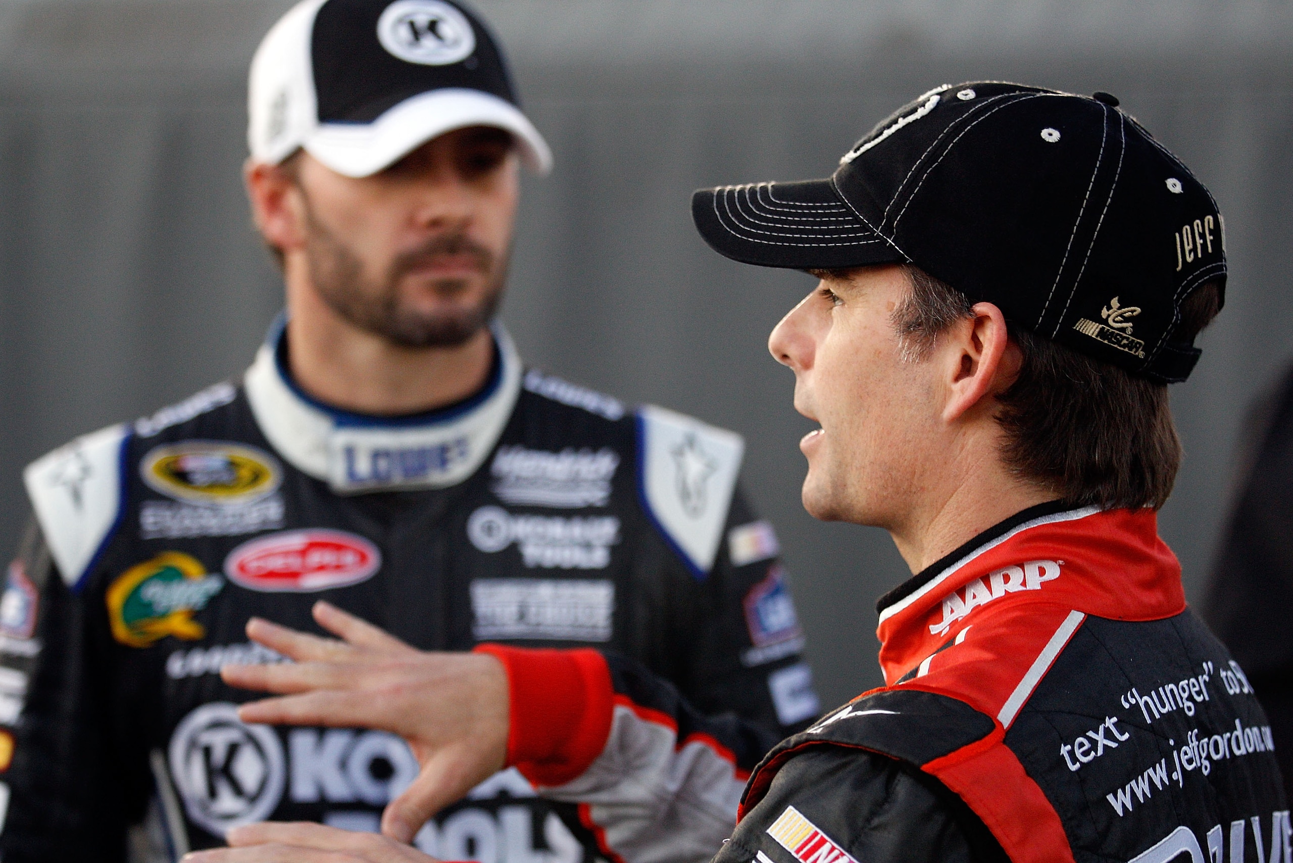 DAYTONA BEACH, FL - FEBRUARY 11:  Jimmie Johnson, driver of the #48 Lowe's Chevrolet, and Jeff Gordon, driver of the #24 Drive to End Hunger Chevrolet, stand in the garage area during practice for the NASCAR Budweiser Shootout at Daytona International Spe
