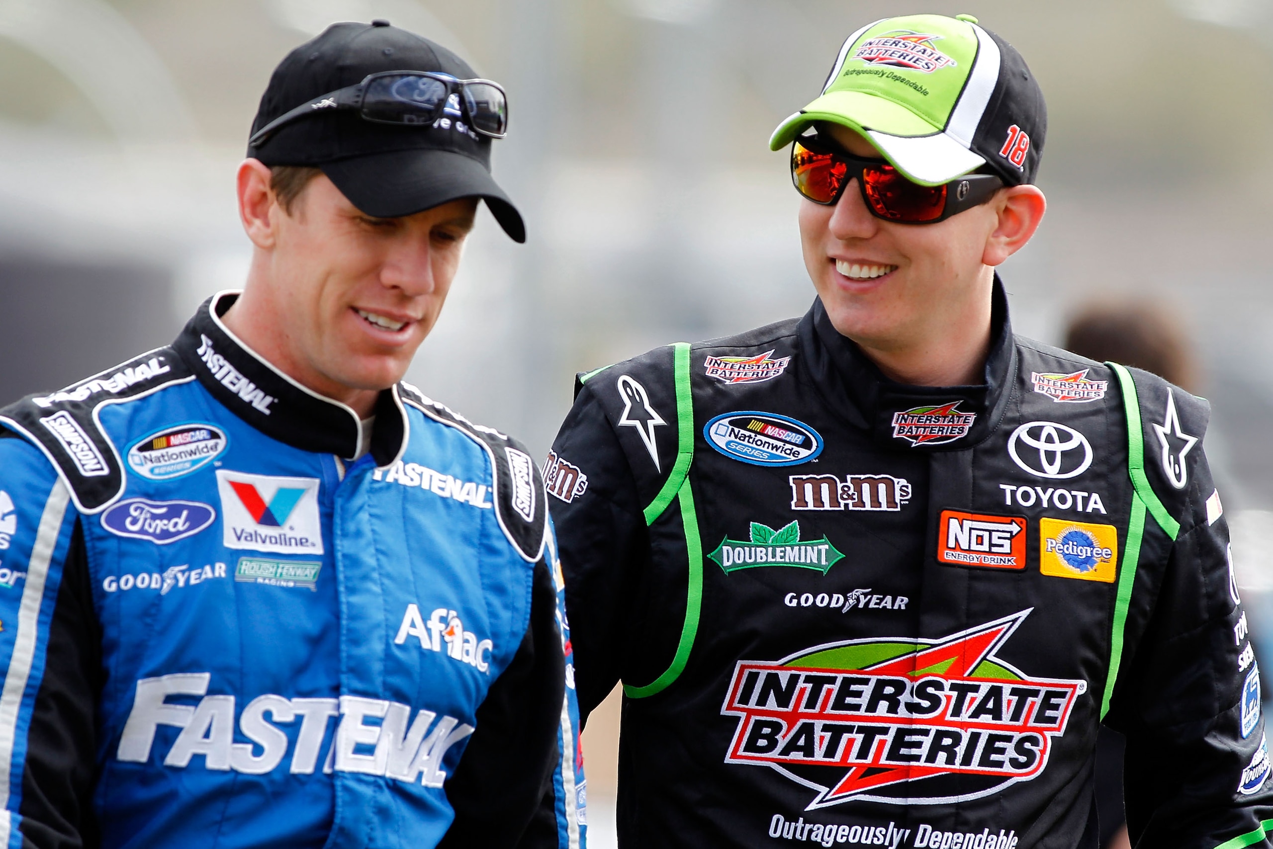 AVONDALE, AZ - FEBRUARY 26:  Carl Edwards, driver of the #60 Fastenal Ford, and Kyle Busch, driver of the #18 Interstate Batteries Toyota, talk during qualifying for the NASCAR Nationwide Series Bashas' Supermarkets 200 at Phoenix International Raceway on