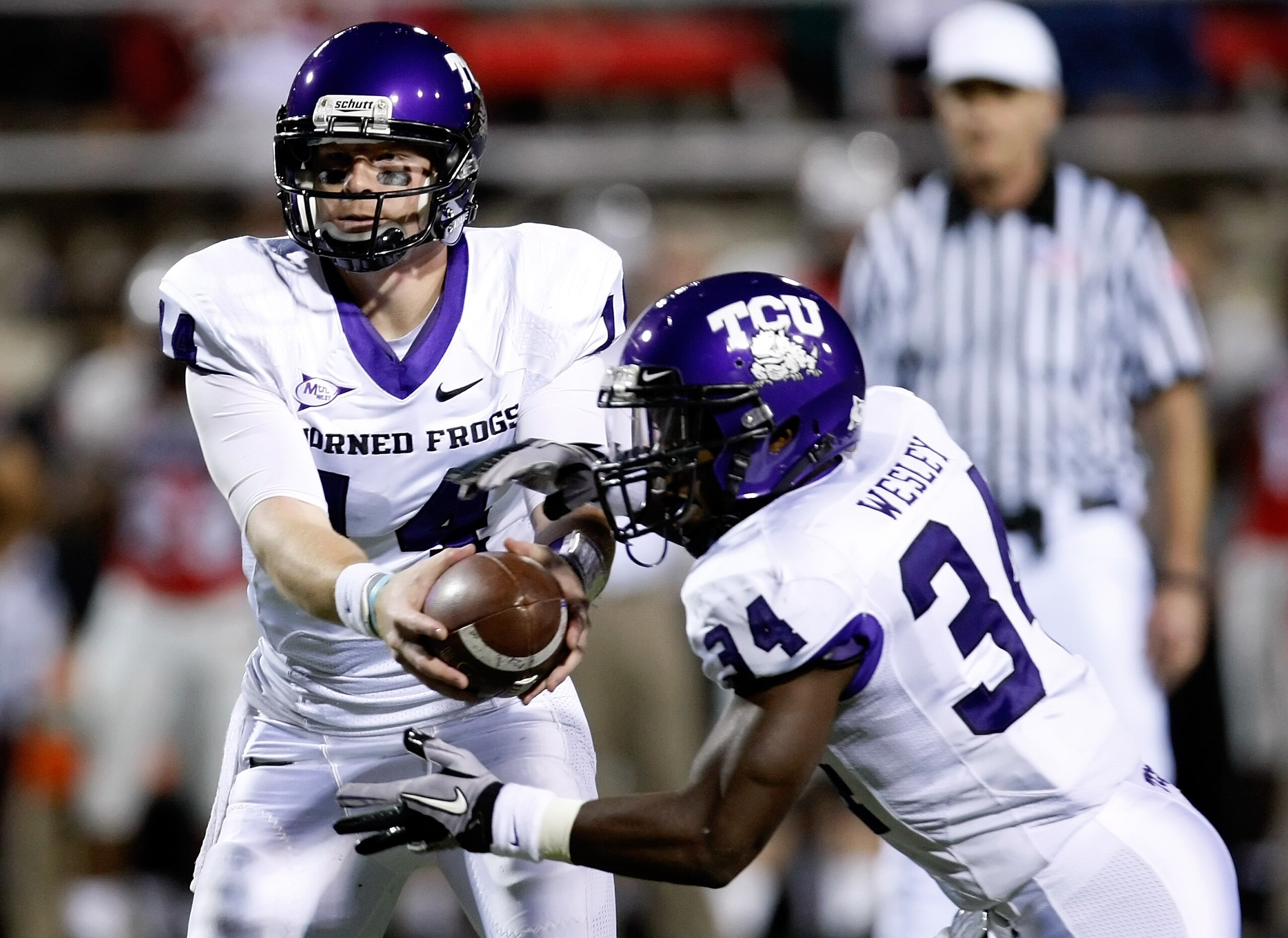 LAS VEGAS - OCTOBER 30:  Quarterback Andy Dalton #14 of the Texas Christian University Horned Frogs hands the ball off to Ed Wesley #34 during their game against the UNLV Rebels at Sam Boyd Stadium October 30, 2010 in Las Vegas, Nevada. TCU won 48-6.  (Ph