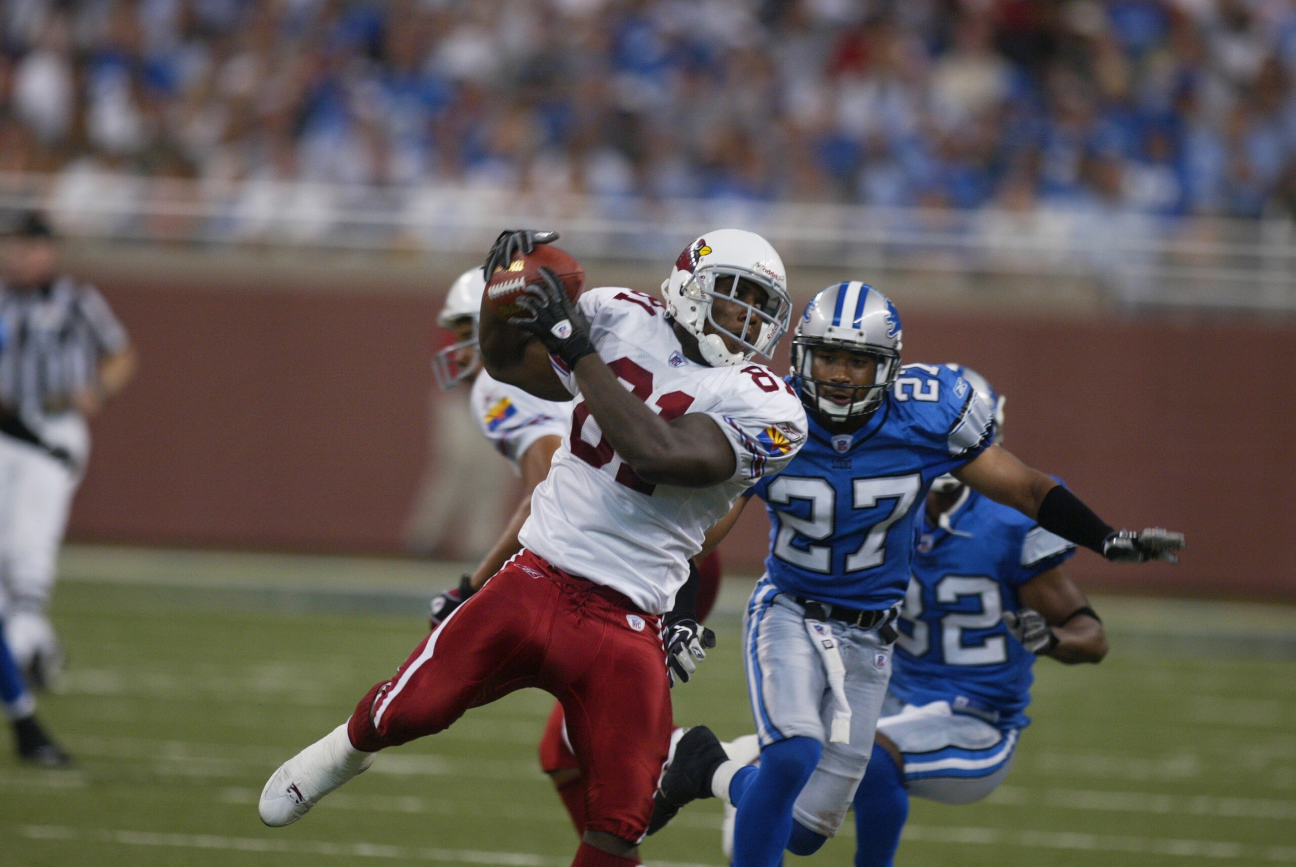 DETROIT, MI - SEPTEMBER 7:  Rookie wide receiver Anquan Boldin #81 of the Arizona Cardinals catches the ball under pressure from cornerback Jimmy Wyrick #27 of the Detroit Lions at Ford Field on September 7, 2003 in Detroit, Michigan. The Lions defeated t