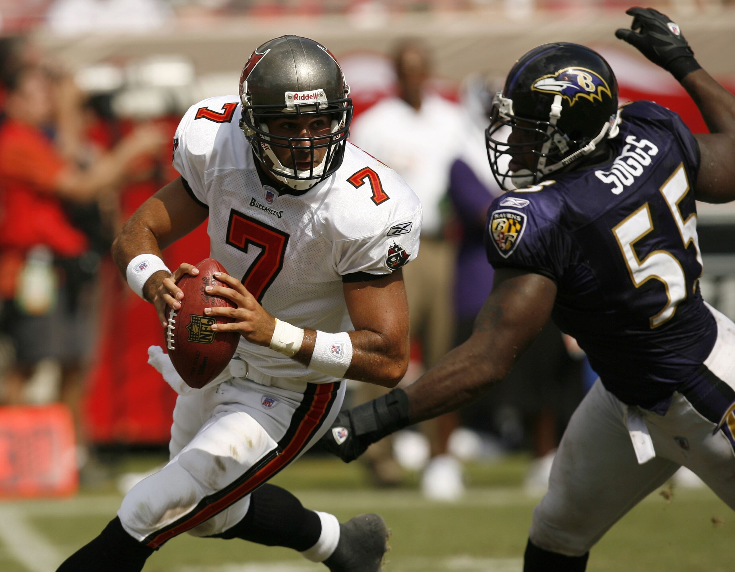 TAMPA, FL - SEPTEMBER 10:  Rookie quarterback Bruce Gradkowski #7 Tampa Bay Buccaneers scrambles away from Terrell Suggs #55 of the Baltimore Ravens on September 10, 2006 at Raymond James Stadium in Tampa, Florida. The Ravens won 27-0. (Photo by Matt Stro