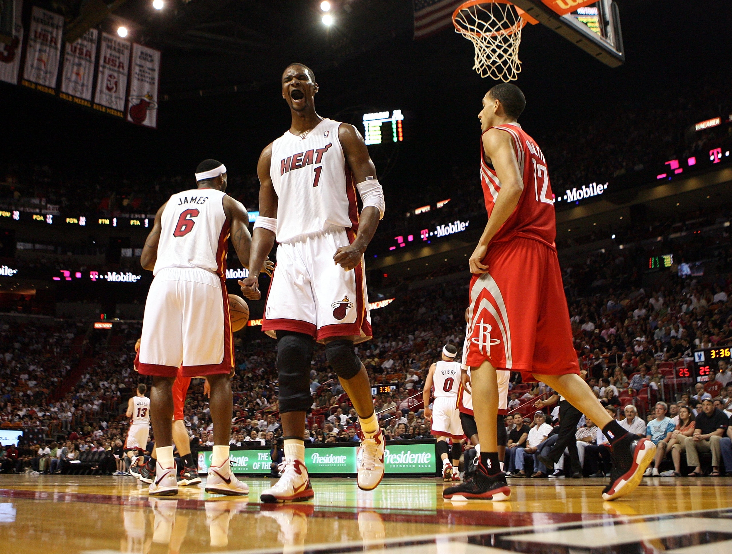 MIAMI, FL - MARCH 27:  Forward Chris Bosh #1 of the Miami Heat reacts against the Houston Rockets  at American Airlines Arena on March 27, 2011 in Miami, Florida. NOTE TO USER: User expressly acknowledges and agrees that, by downloading and/or using this