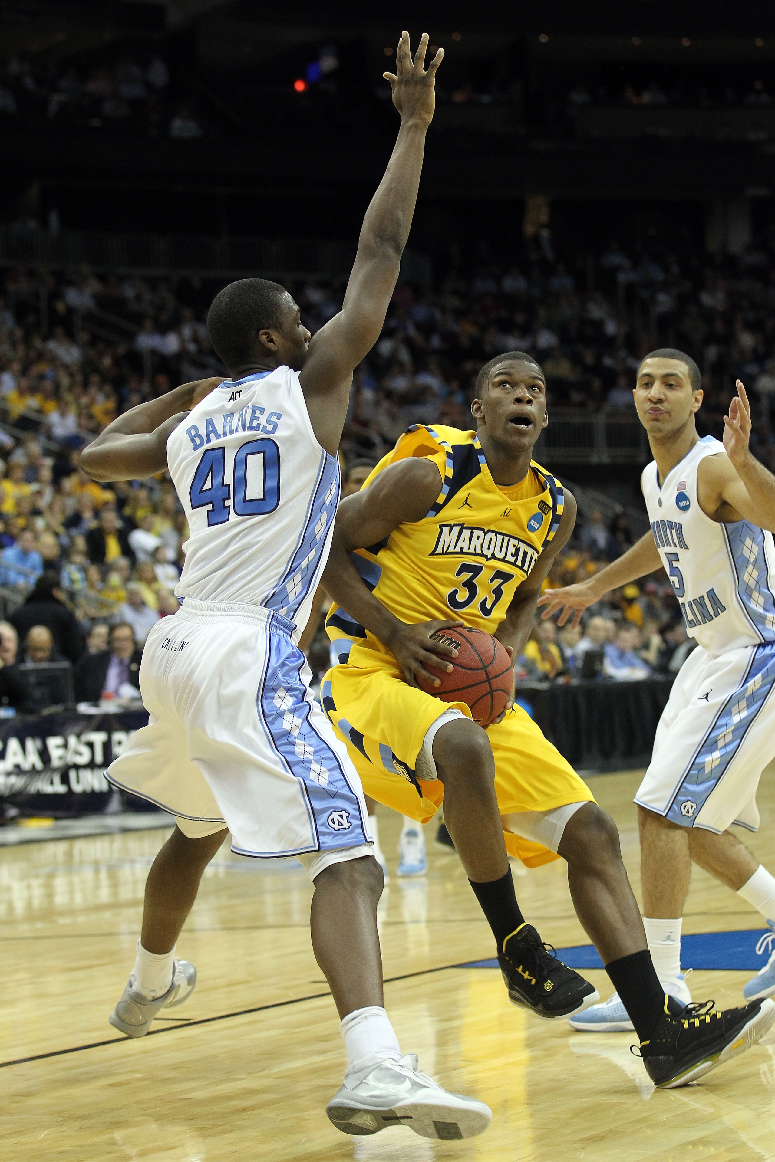 NEWARK, NJ - MARCH 25: Jimmy Butler #33 of the Marquette Golden Eagles against Harrison Barnes #40 of the North Carolina Tar Heels during the east regional semifinal of the 2011 NCAA Men's Basketball Tournament at the Prudential Center on March 25, 2011 NEWARK, NJ - MARCH 25: Jimmy Butler #33 of the Marquette Golden Eagles against Harrison Barnes #40 of the North Carolina Tar Heels during the east regional semifinal of the 2011 NCAA Men's Basketball Tournament at the Prudential Center on March 25, 2011