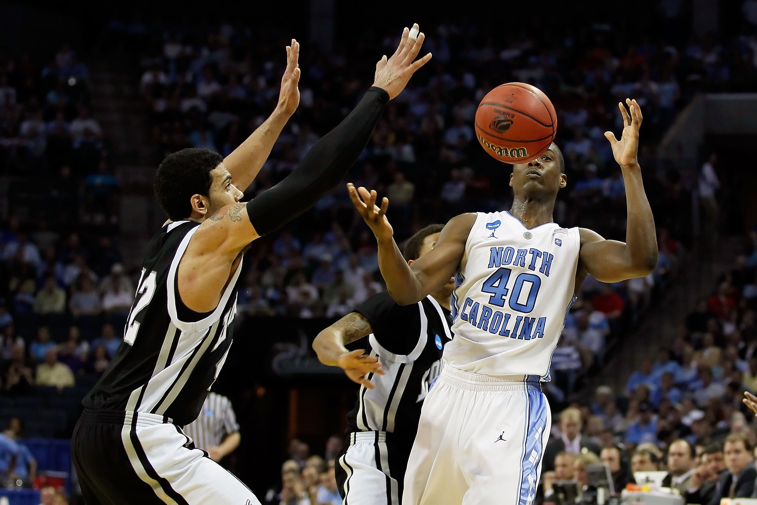 CHARLOTTE, NC - MARCH 18: Harrison Barnes #40 of the North Carolina Tar Heels looses the ball alongside Julian Boyd #42 of the Long Island Blackbirds in the second half during the second round of the 2011 NCAA men's basketball tournament at Time Warner C CHARLOTTE, NC - MARCH 18: Harrison Barnes #40 of the North Carolina Tar Heels looses the ball alongside Julian Boyd #42 of the Long Island Blackbirds in the second half during the second round of the 2011 NCAA men's basketball tournament at Time Warner C