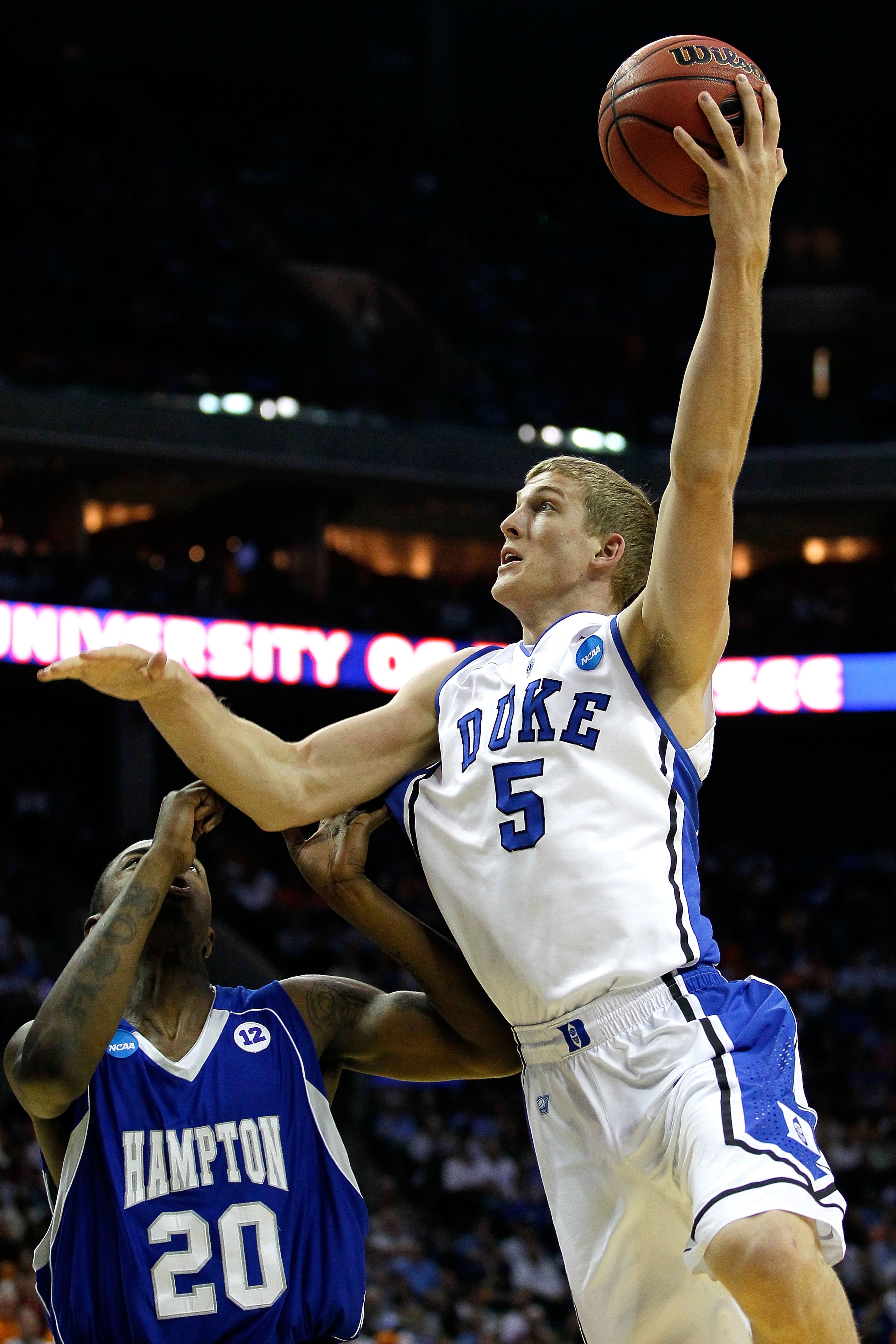 CHARLOTTE, NC - MARCH 18:  Mason Plumlee #5 of the Duke Blue Devils shoots over Charles Funches #20 of the Hampton Pirates in the first half during the second round of the 2011 NCAA men's basketball tournament at Time Warner Cable Arena on March 18, 2011