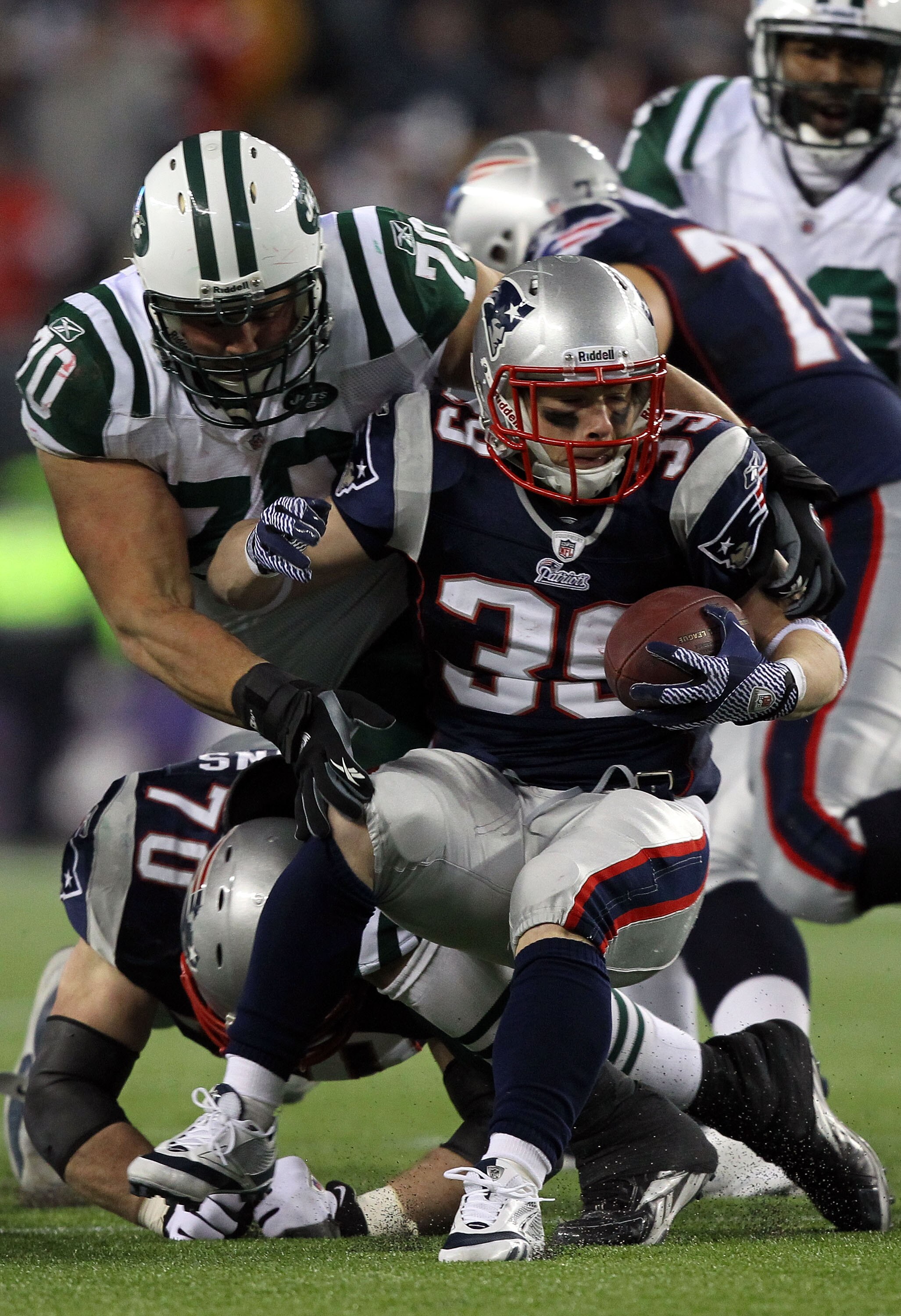 FOXBORO, MA - JANUARY 16:  Mike DeVito #70 of the New York Jets tackles Danny Woodhead #39 of the New England Patriots during their 2011 AFC divisional playoff game at Gillette Stadium on January 16, 2011 in Foxboro, Massachusetts.  (Photo by Al Bello/Get