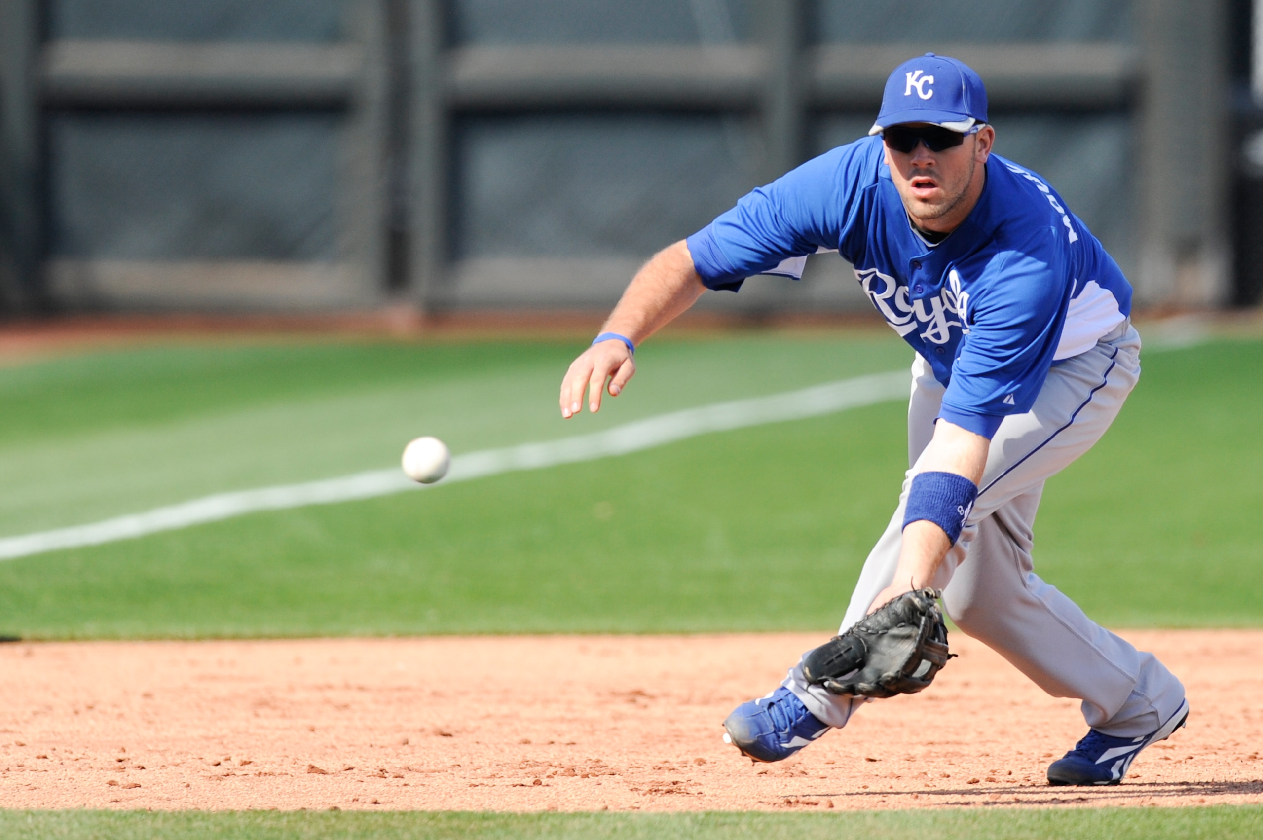 SURPISE, AZ - FEBRUARY 27: Mike Moustakas #8 of the Kansas City Royals field a ground ball during a spring training game against the Texas Rangers at Surprise Stadium on February 27, 2011 in Surprise, Arizona. (Photo by Rob Tringali/Getty Images)