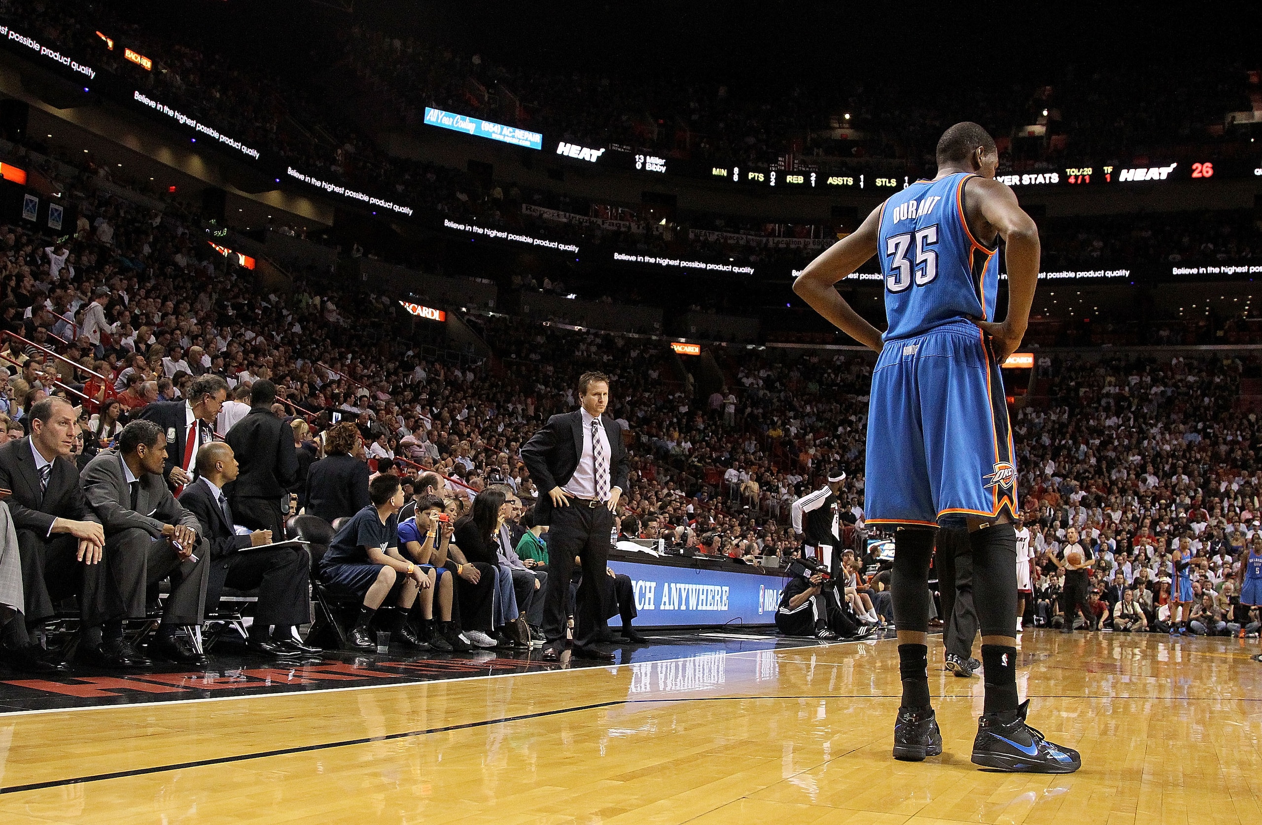 MIAMI, FL - MARCH 16:  Kevin Durant #35 of the Oklahoma City Thunder looks on with head coach Scott Brooks during a game against the Miami Heat at American Airlines Arena on March 16, 2011 in Miami, Florida. NOTE TO USER: User expressly acknowledges and a