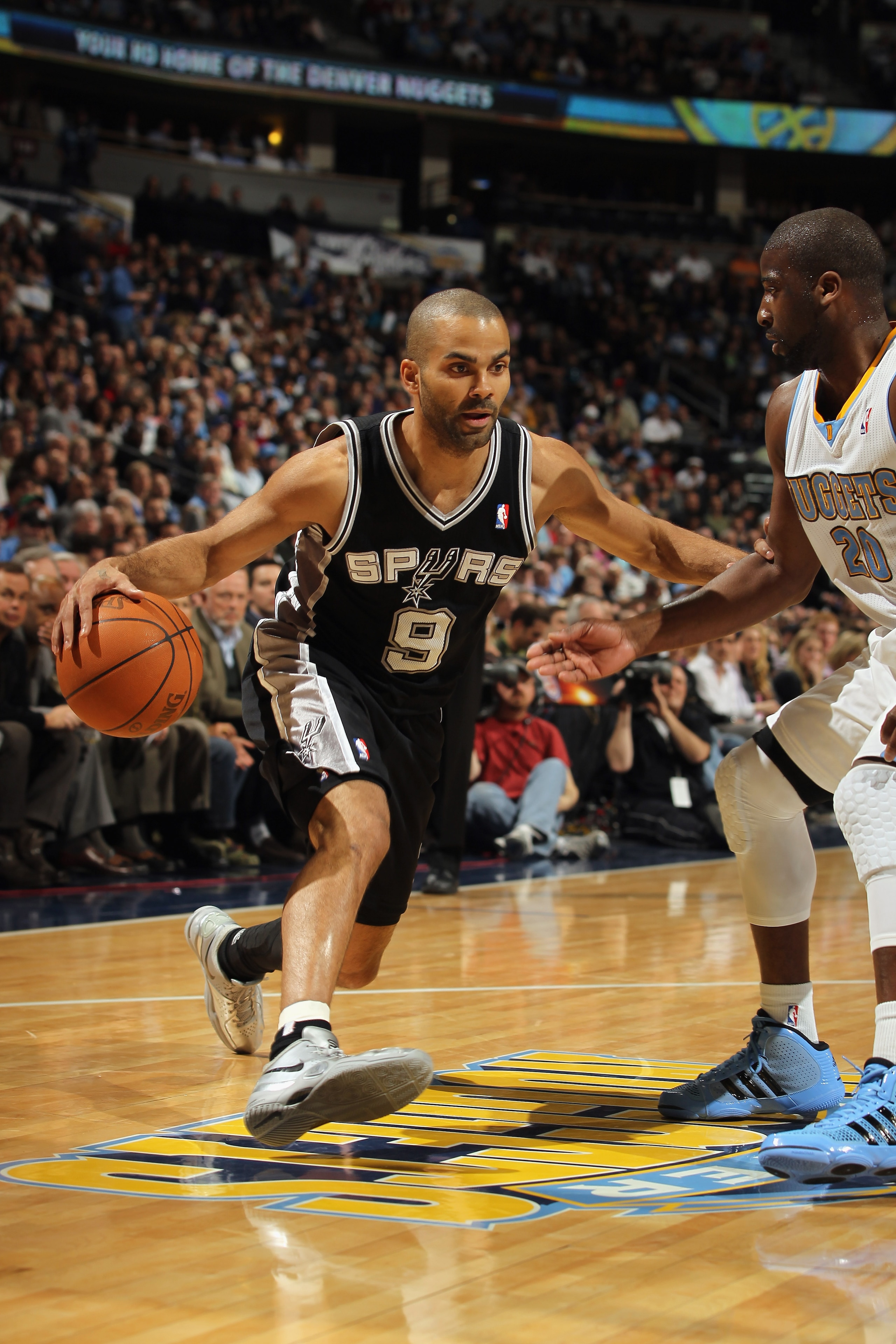 DENVER, CO - MARCH 23:  Tony Parker #9 of the San Antonio Spurs dribbles the ball against  the Denver Nuggets at the Pepsi Center on March 23, 2011 in Denver, Colorado. The Nuggets defeated the Spurs 115-112. NOTE TO USER: User expressly acknowledges and