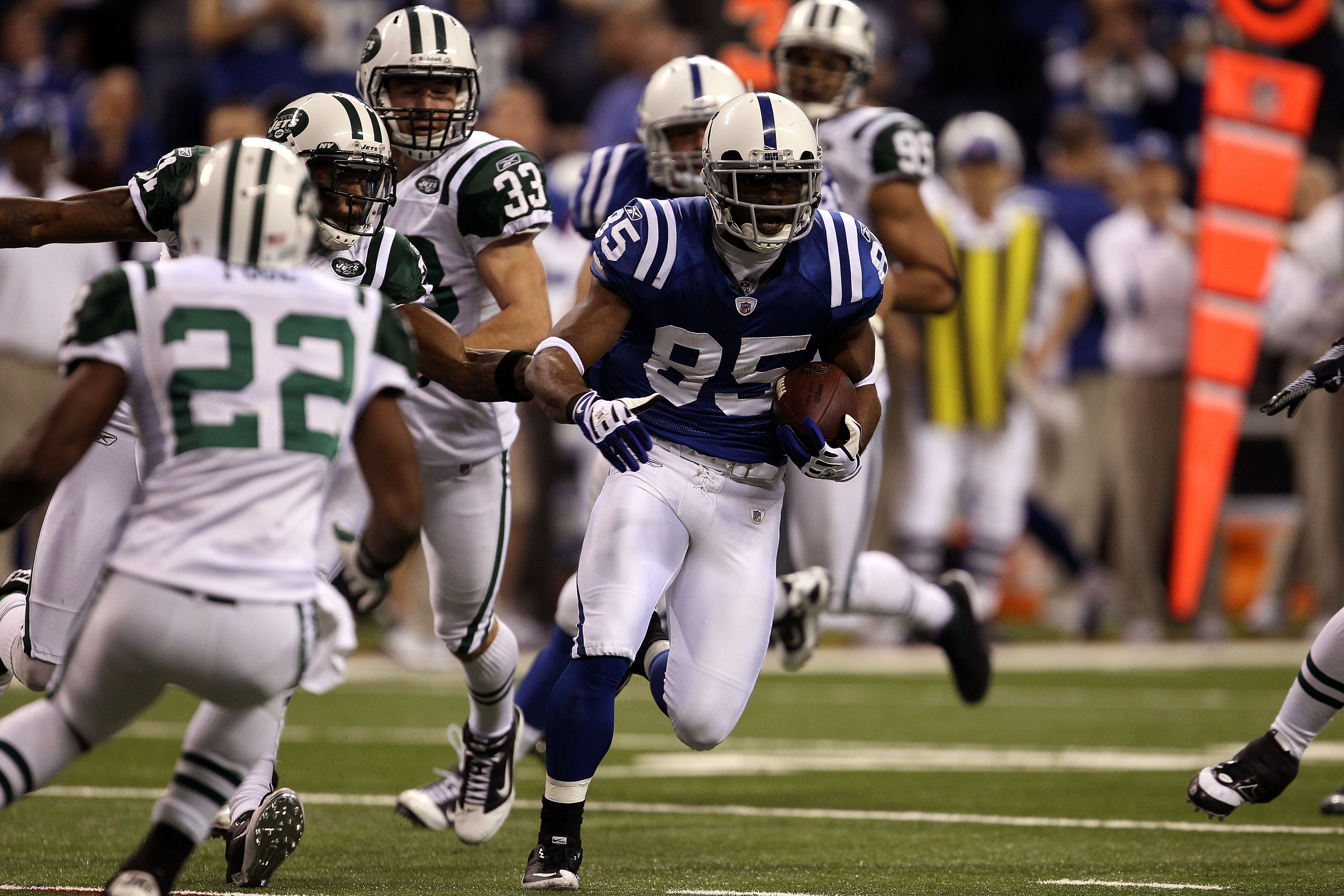 INDIANAPOLIS, IN - JANUARY 08:  Pierre Garcon #85 of the Indianapolis Colts runs for yards after the catch against the New York Jets during their 2011 AFC wild card playoff game at Lucas Oil Stadium on January 8, 2011 in Indianapolis, Indiana. The Jets wo