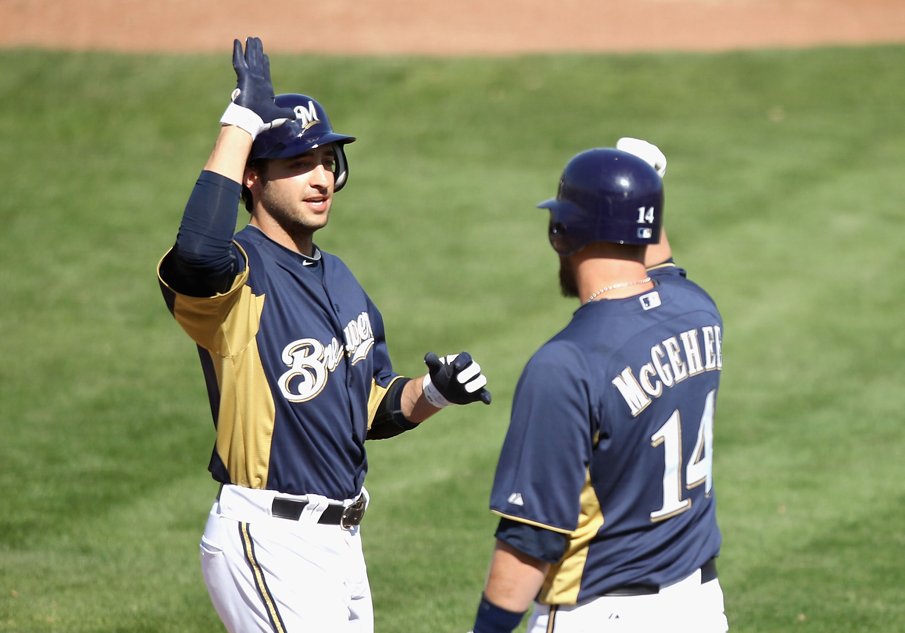 PHOENIX, AZ - MARCH 03:  Ryan Braun #8 of the Milwaukee Brewers high fives teammate Casey McGehee #14 after Braun hit a 2 run home run against the Oakland Athletics during the third inning of the spring training game at Maryvale Baseball Park on March 3,