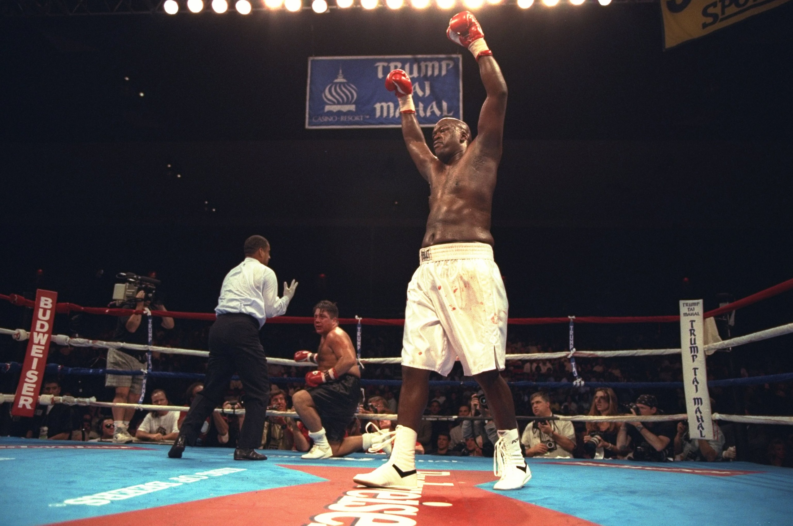 22 Jul 1996: Buster Douglas celebrates after knocking down Tony La Rosa during the Buster Douglas v Tony La Rosa fight at the Trump Taj Mahal in Atlantic City, New Jersey. Douglas won the fight fight in the third round by TKO.