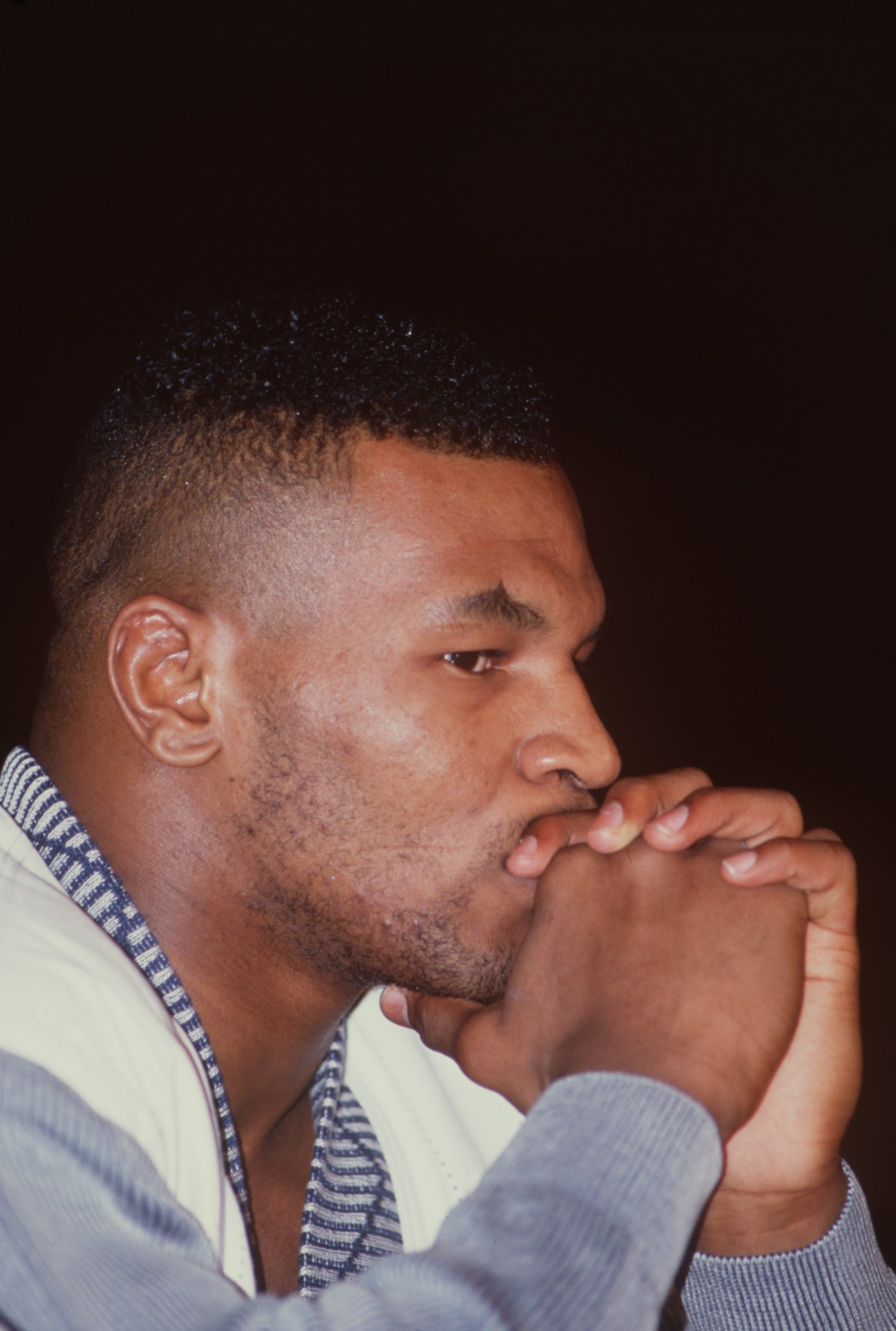 25 FEB 1989:  CHAMPION MIKE TYSON LOOKS PENSIVE AS HE RESTS HIS CHIN IN HIS HANDS IN THIS PORTRAIT TAKEN DURING THE PRESS CONFERENCE BEFORE HIS HEAVYWEIGHT CHAMPIONSHIP FIGHT AGAINST CHALLENGER FRANK BRUNO OF GREAT BRITAIN AT THE HILTON IN LAS VEGAS. Mand