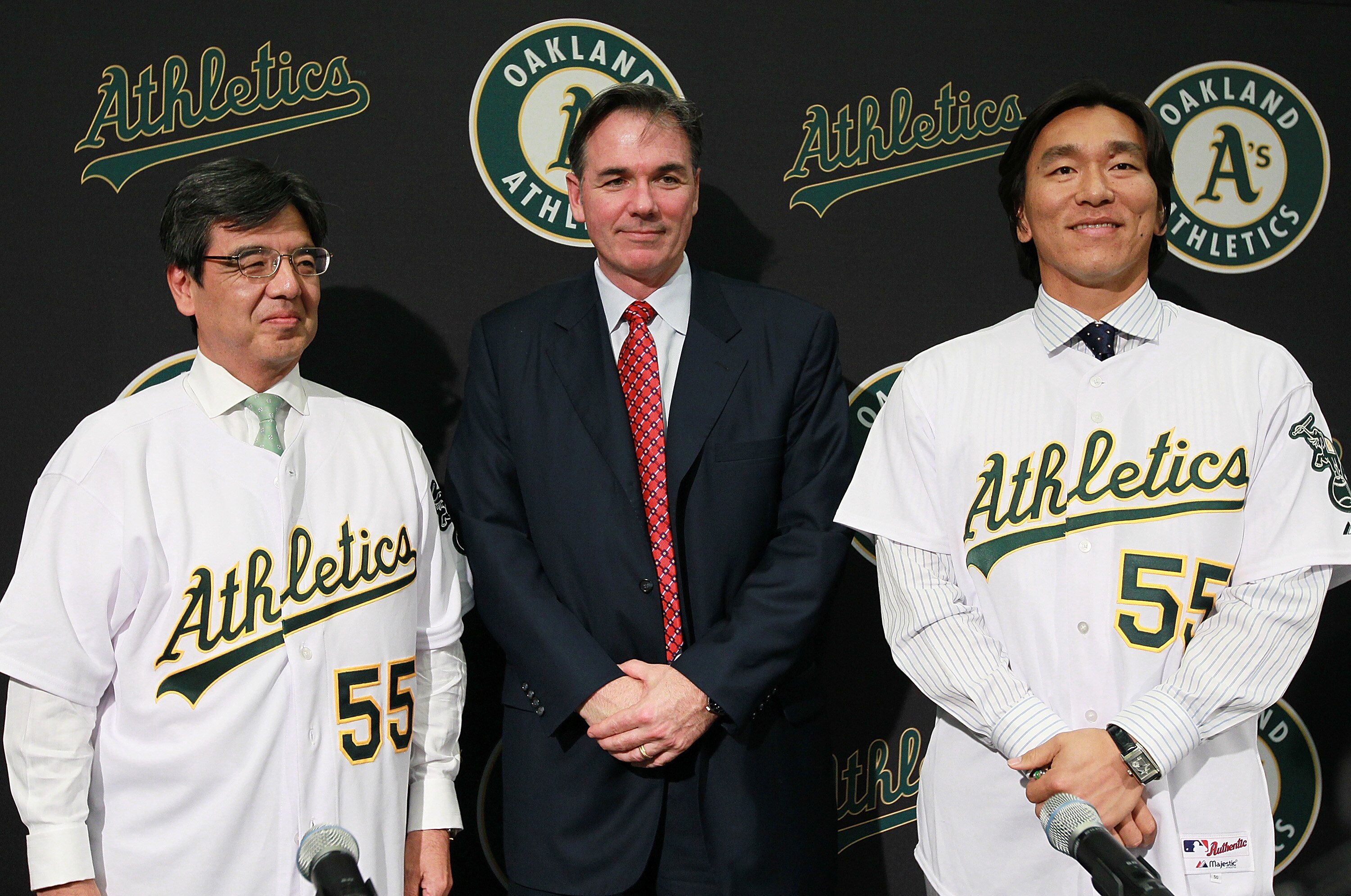 OAKLAND, CA - DECEMBER 14:  Hideki Matsui (R) stands with Oakland Athletics general manager Billy Beane (C) and San Francisco Consul General Hiroshi Inomata (L) pose for a photograph during a press conference where he was introduced as the newest member o