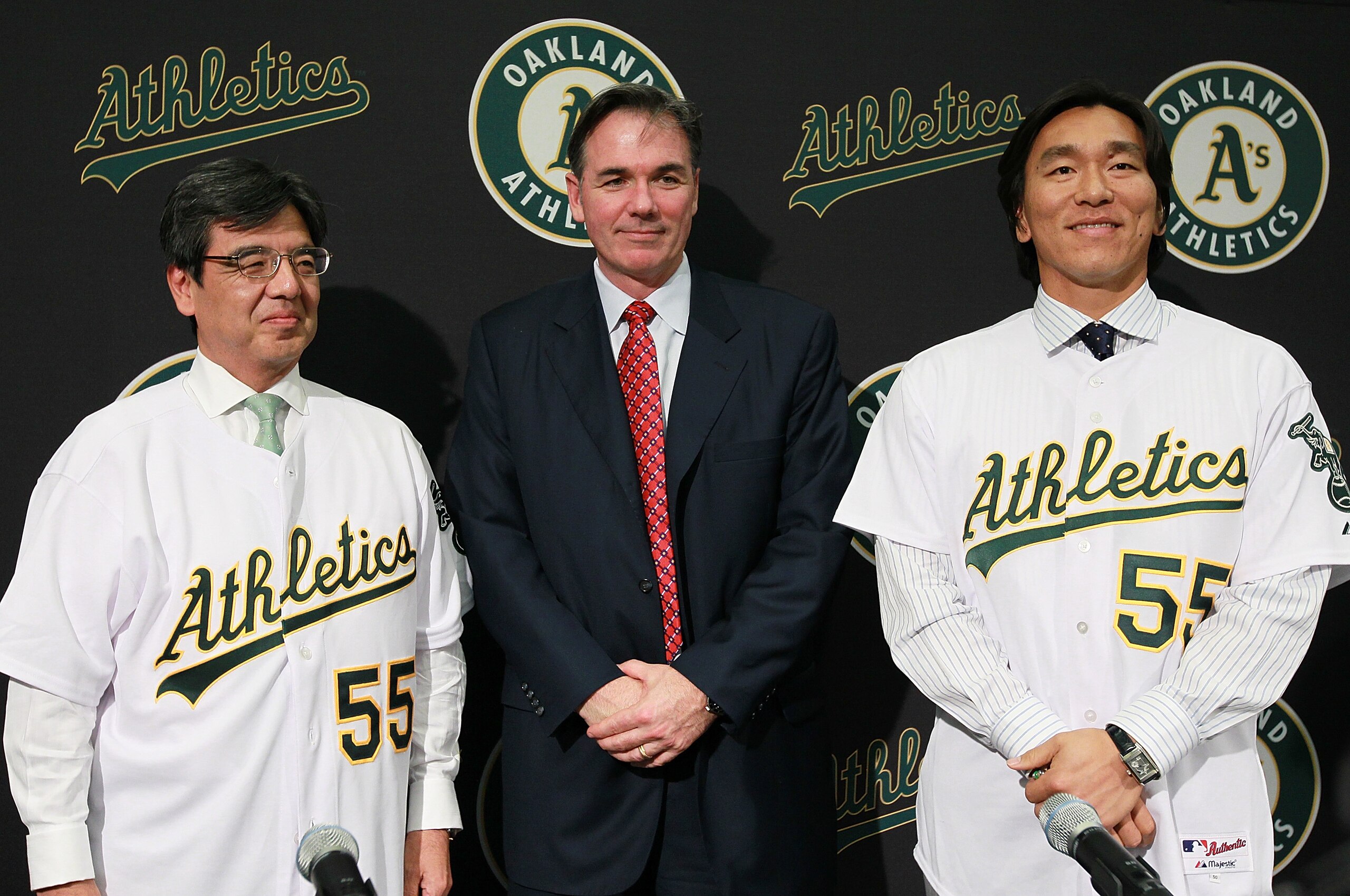 OAKLAND, CA - DECEMBER 14:  Hideki Matsui (R) stands with Oakland Athletics general manager Billy Beane (C) and San Francisco Consul General Hiroshi Inomata (L) pose for a photograph during a press conference where he was introduced as the newest member o
