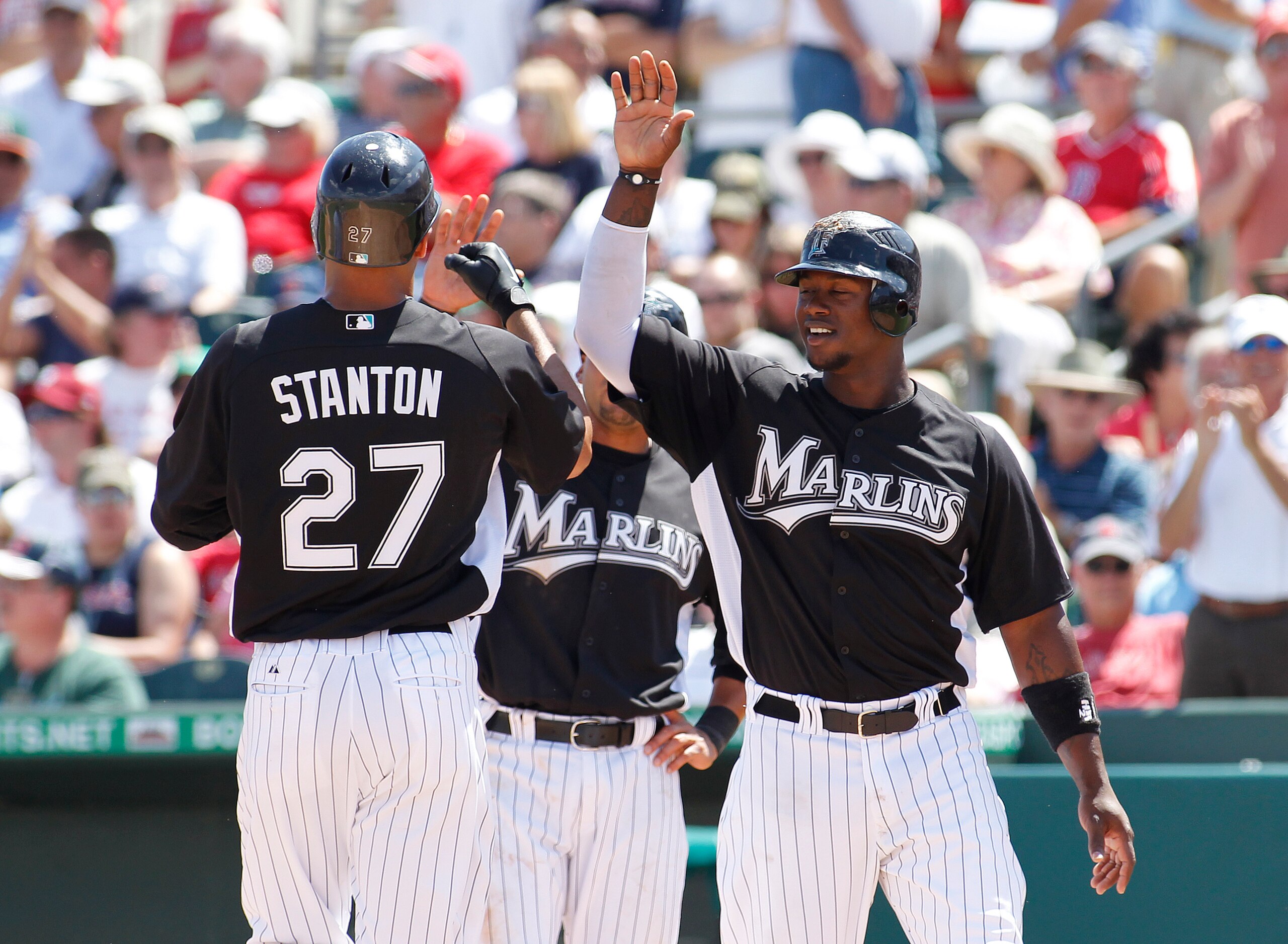 JUPITER, FL - MARCH 24: Mike Stanton #27 is congratulated by Hanley Ramirez #2 of the Florida Marlins after hitting a three run home run against the Boston Red Sox at Roger Dean Stadium on March 24, 2011 in Jupiter, Florida. (Photo by Joel Auerbach/Getty