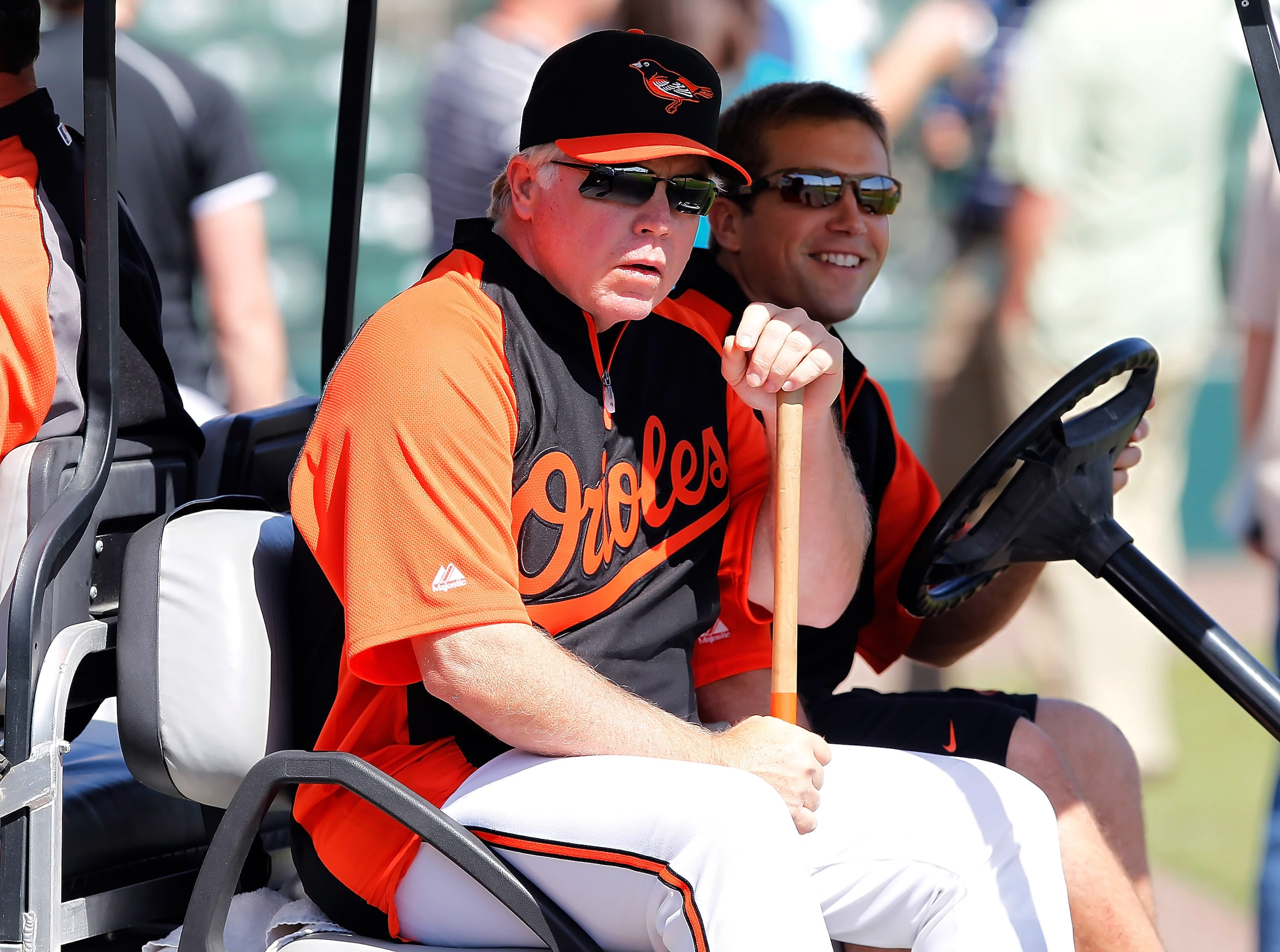 SARASOTA, FL - MARCH 03:  Manager Buck Showalter #26 of the Baltimore Orioles gets a ride back to the clubhouse just before the start of the Grapefruit League Spring Training Game against the Minnesota Twins at Ed Smith Stadium on March 3, 2011 in Sarasot