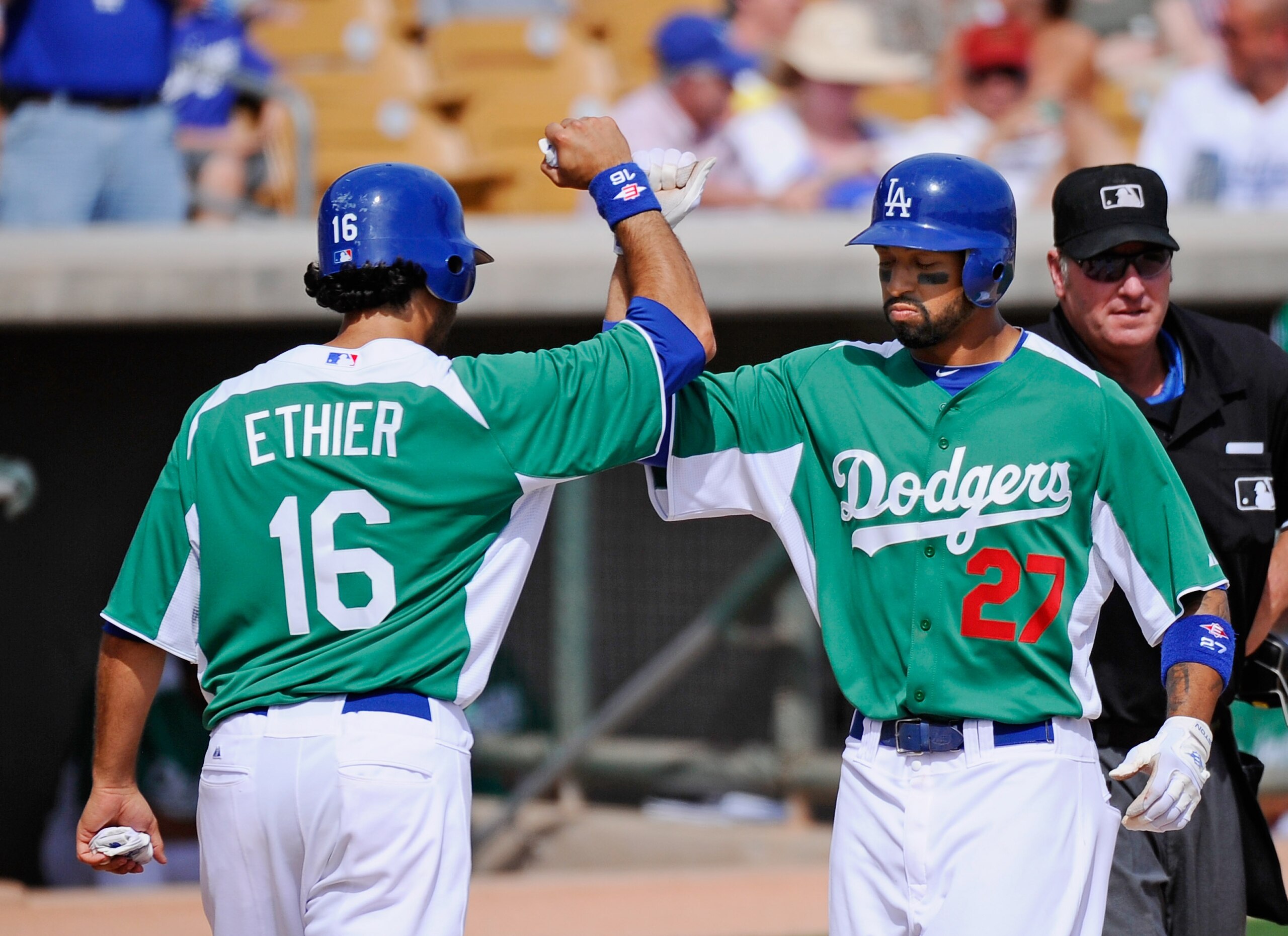 GLENDALE, AZ - MARCH 17: Matt Kemp #27 and Andre Eithier #16 of the Los Angeles Dodgers wearing a green jersey in celebration of St. Patrick's Day high five after Kemp hit a two run home run against the Arizona Diamondbacks during the spring training base