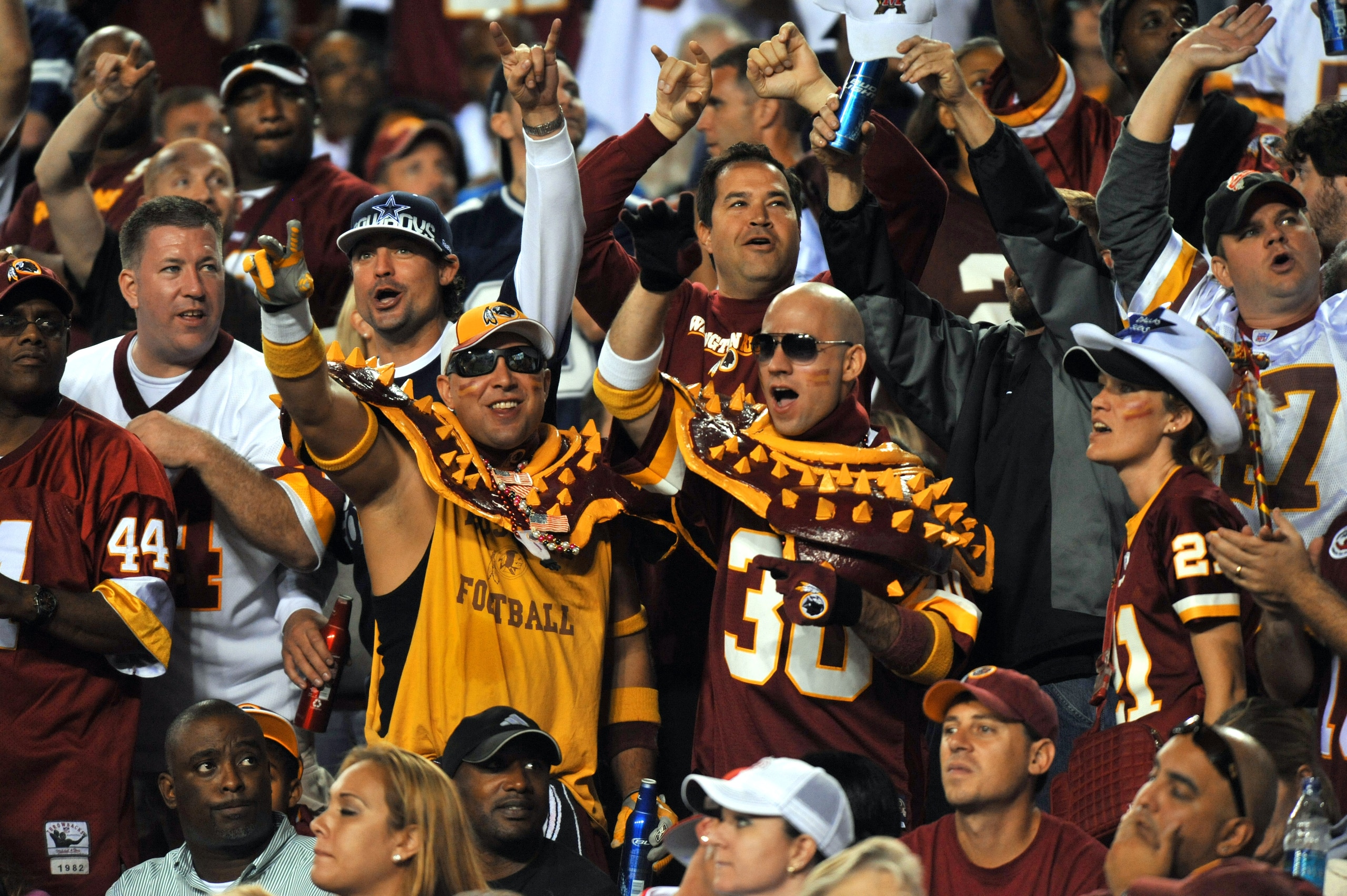 LANDOVER - SEPTEMBER 12:  Fans of the Washington Redskins cheer during the NFL season opener against the Dallas Cowboys at FedExField on September 12, 2010 in Landover, Maryland. The Redskins defeated the Cowboys 13-7. (Photo by Larry French/Getty Images)