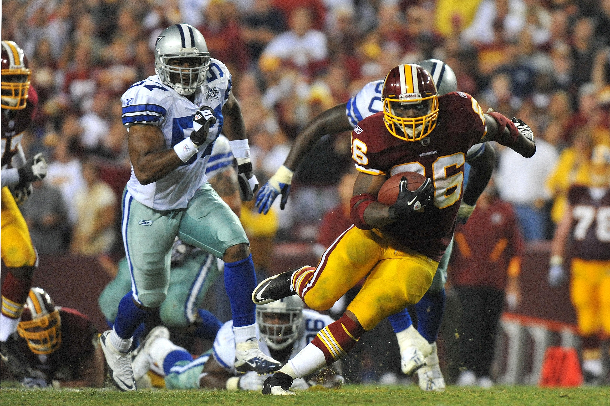 LANDOVER - SEPTEMBER 12:  Clinton Portis #26 of the Washington Redskins runs the ball during the NFL season opener against the Dallas Cowboys at FedExField on September 12, 2010 in Landover, Maryland. The Redskins defeated the Cowboys 13-7. (Photo by Larr
