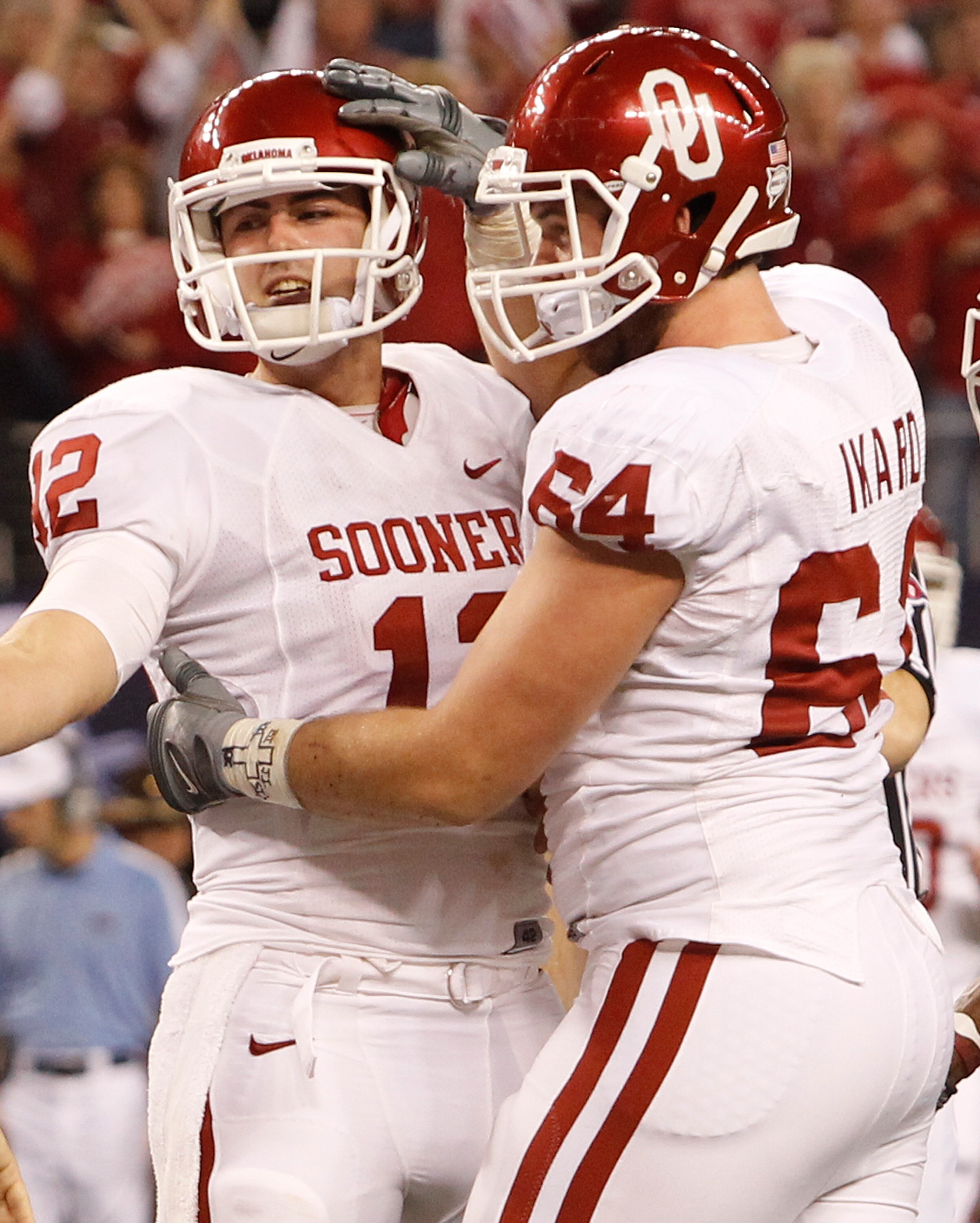 ARLINGTON, TX - DECEMBER 04:  Quarterback Landry Jones #12 of the Oklahoma Sooners celebrates with guard Gabe Ikard #64 after Jones scored against the Nebraska Cornhuskers at Cowboys Stadium on December 4, 2010 in Arlington, Texas.  (Photo by Tom Penningt