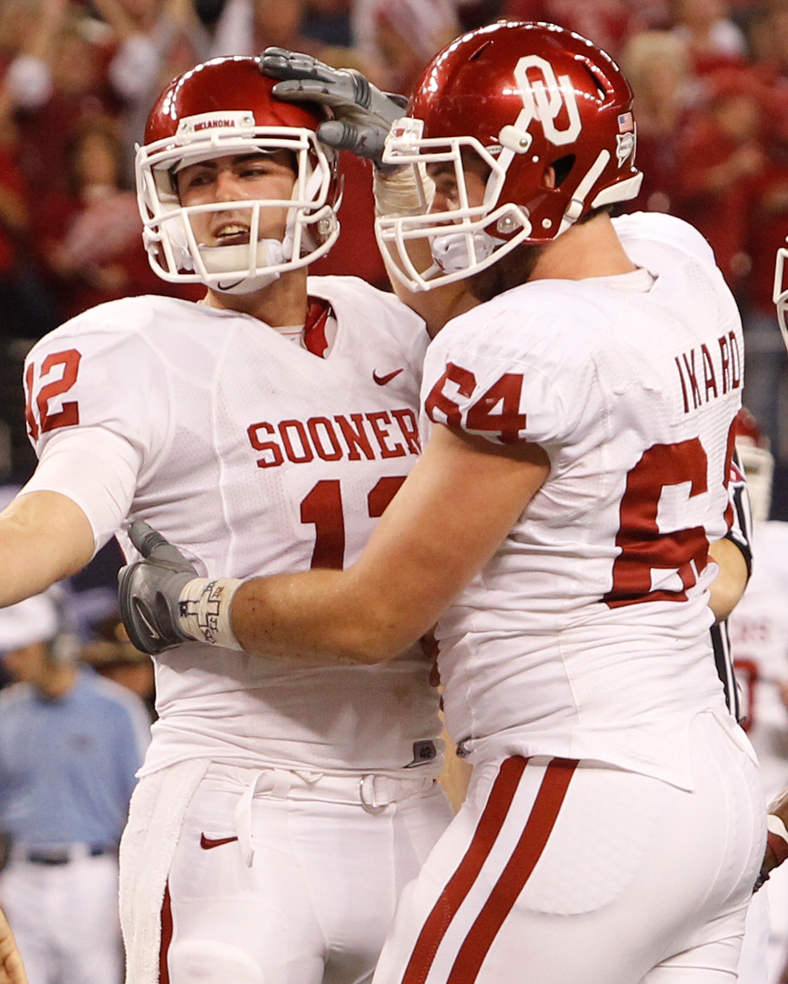 ARLINGTON, TX - DECEMBER 04:  Quarterback Landry Jones #12 of the Oklahoma Sooners celebrates with guard Gabe Ikard #64 after Jones scored against the Nebraska Cornhuskers at Cowboys Stadium on December 4, 2010 in Arlington, Texas.  (Photo by Tom Penningt