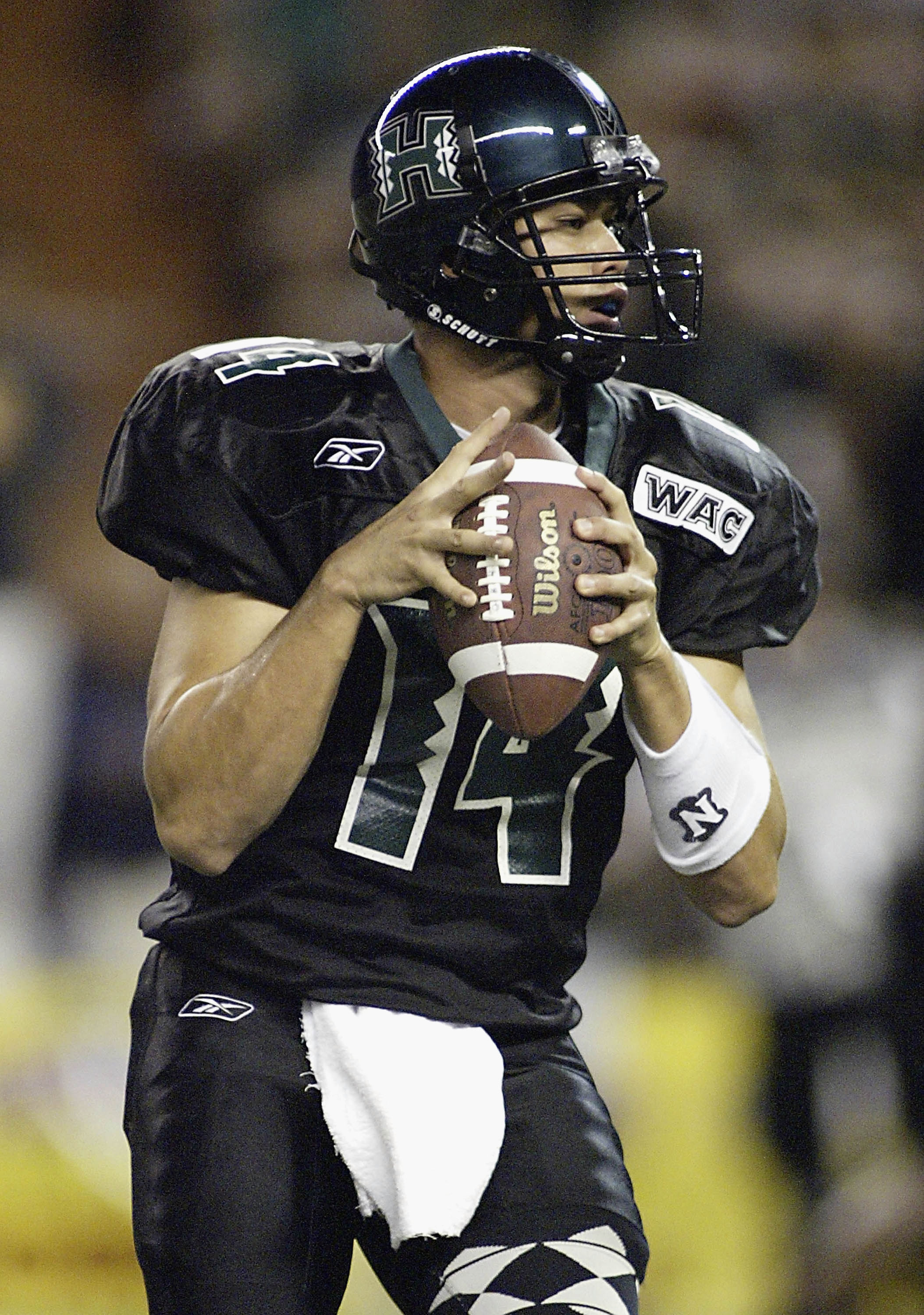 HONOLULU, HI - NOVEMBER 6:  University of Hawaii quarterback Timmy Chang looks to pass during the game between University of Hawaii and Louisiana Tech University at Aloha Stadium, November 6, 2004 in Honolulu, Hawaii. (Photo by Marco Garcia/Getty Images)