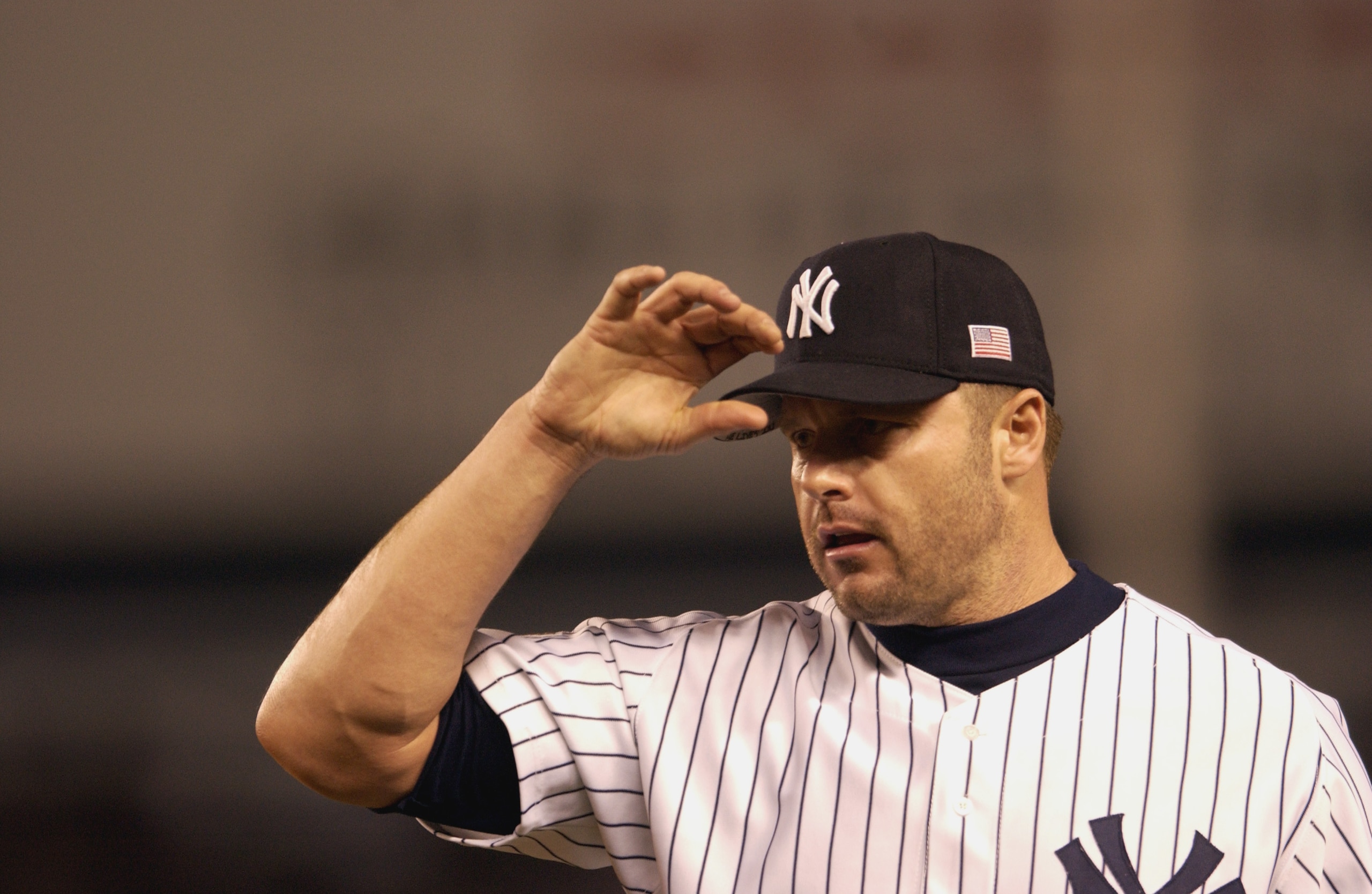 BRONX, NY - OCTOBER 21:  Pitcher Roger Clemens #22 of the New York Yankees adjusts his cap during Game 4 of the ALCS against the Seattle Mariners on October 21, 2001 at Yankee Stadium in the Bronx, New York.  The Yankees won 3-1. (Photo by M. David Leeds/