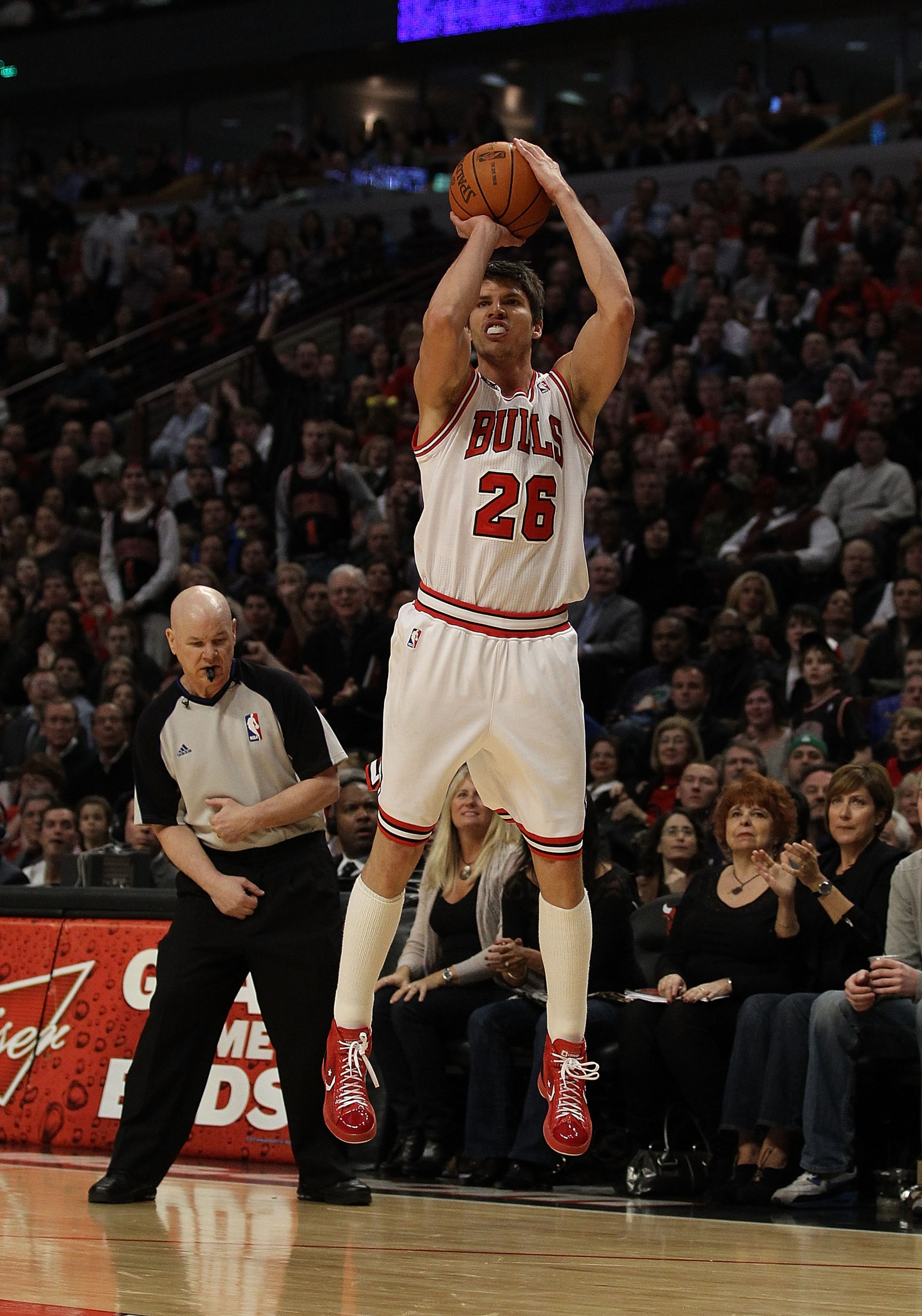 CHICAGO, IL - MARCH 25: Kyle Korver #26 of the Chicago Bulls puts up a 3 point shot in front of referee Joey Crawford #17 against the Memphis Grizzlies at the United Center on March 25, 2011 in Chicago, Illinois. The Bulls defeated the Grizzlies 99-96. NO