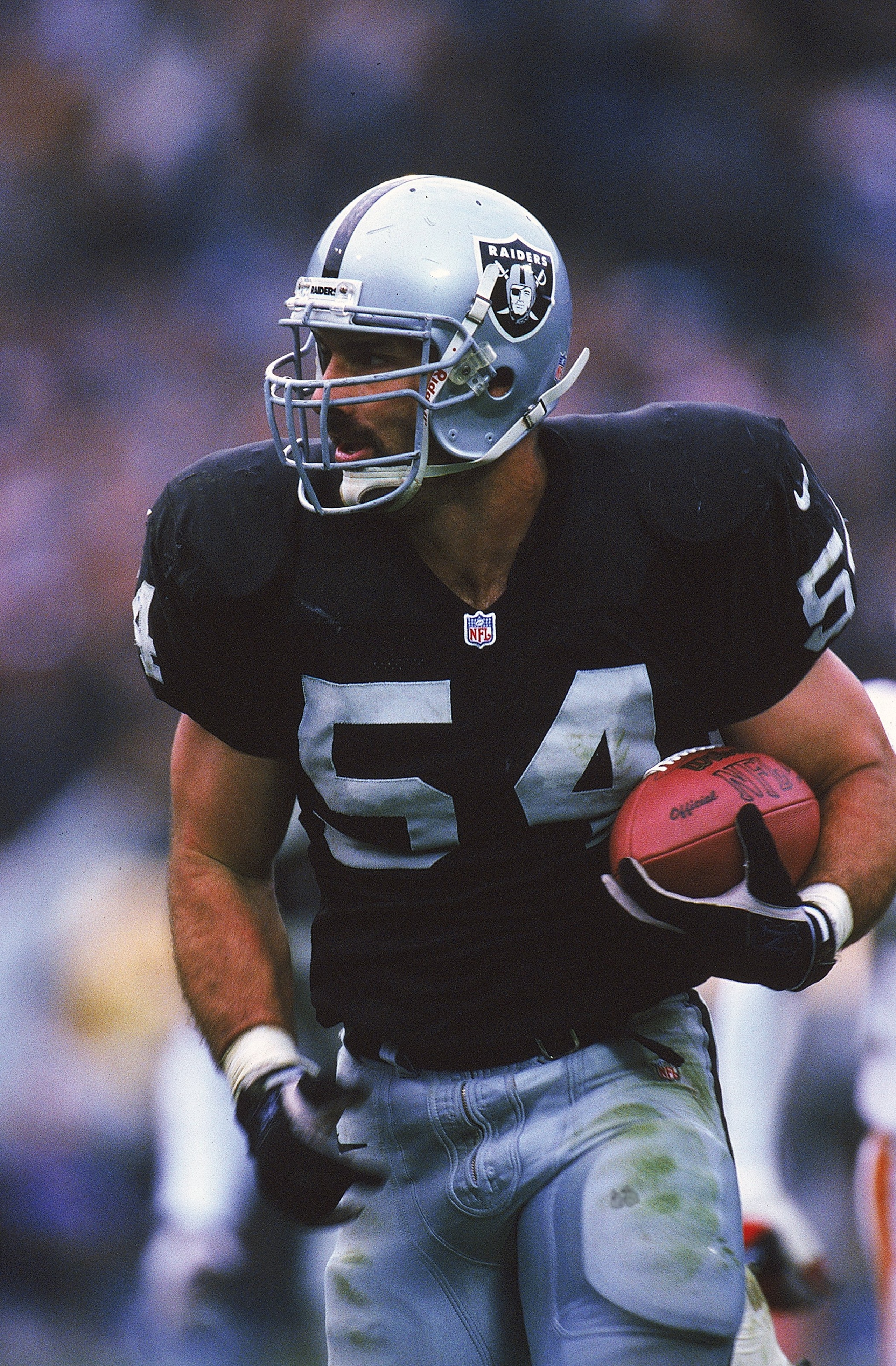 28 Nov 1999:  Greg Biekert #54 of the Oakland Raiders holds the ball and looks on during the game against the Kansas City Chiefs at the Network Associates Coliseum in Oakland, California. The Chiefs defeated the Raiders 37-34. Mandatory Credit: Harry How