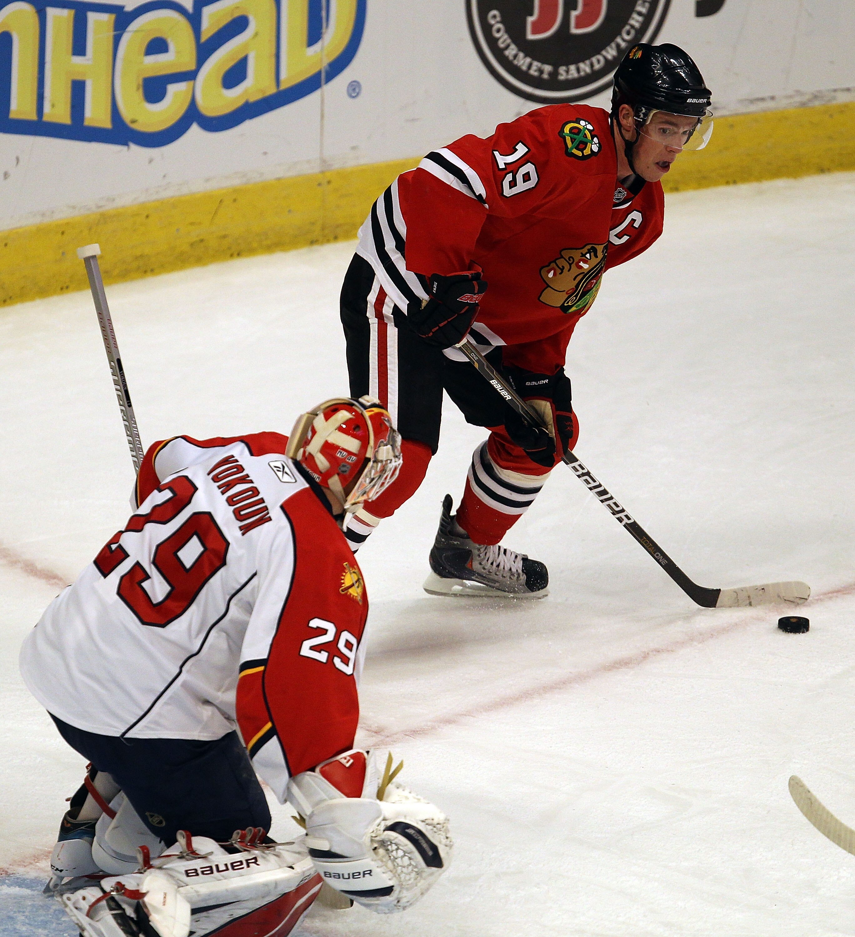 CHICAGO, IL - MARCH 23: Jonathan Toews #19 of the Chicago Blackhawks looks to pass as Tomas Vokoun #29 of the Florida Panthers watches at the United Center on March 23, 2011 in Chicago, Illinois. The Blackhawks defeated the Panthers 4-0. (Photo by Jonatha