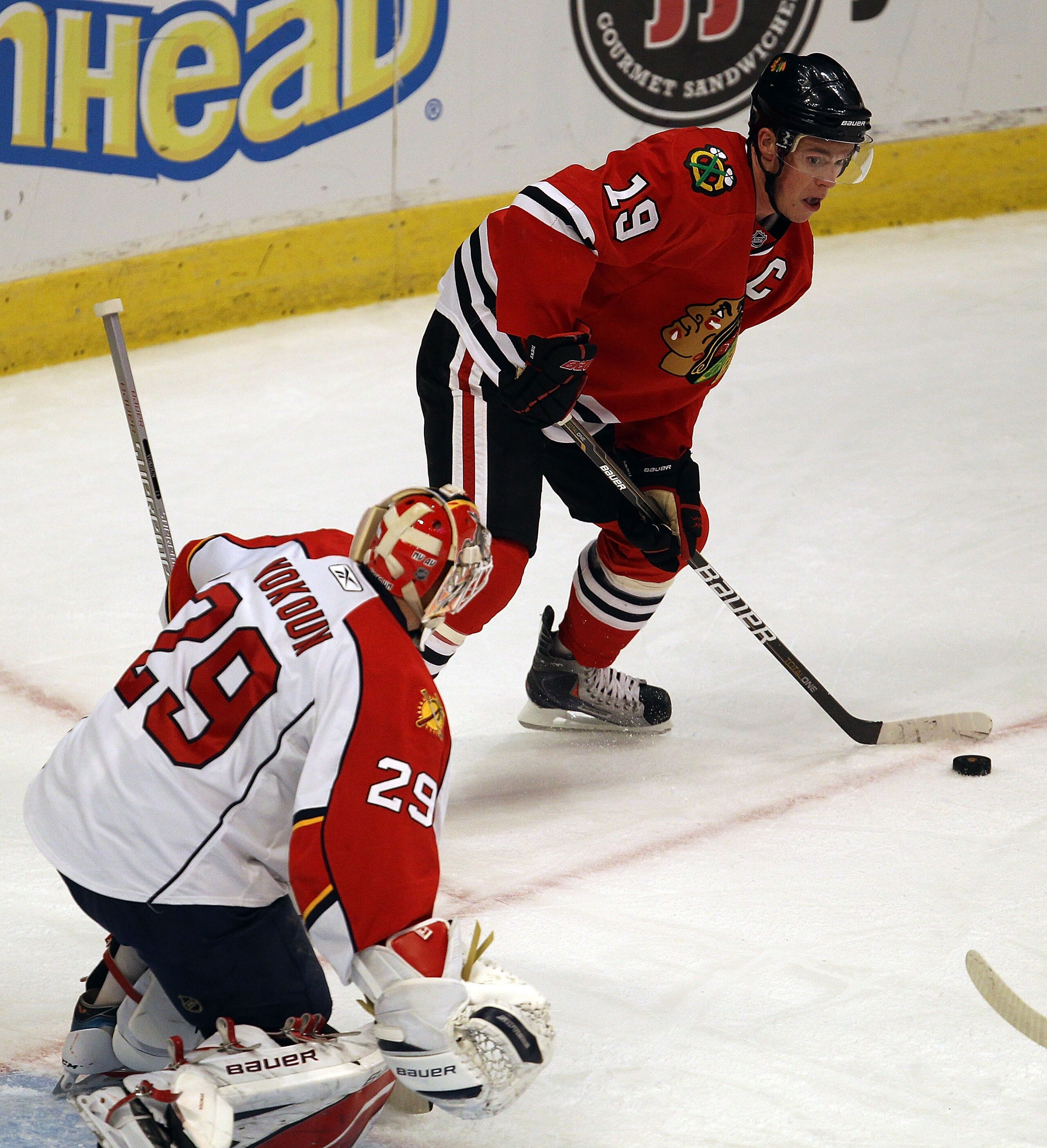 CHICAGO, IL - MARCH 23: Jonathan Toews #19 of the Chicago Blackhawks looks to pass as Tomas Vokoun #29 of the Florida Panthers watches at the United Center on March 23, 2011 in Chicago, Illinois. The Blackhawks defeated the Panthers 4-0. (Photo by Jonatha