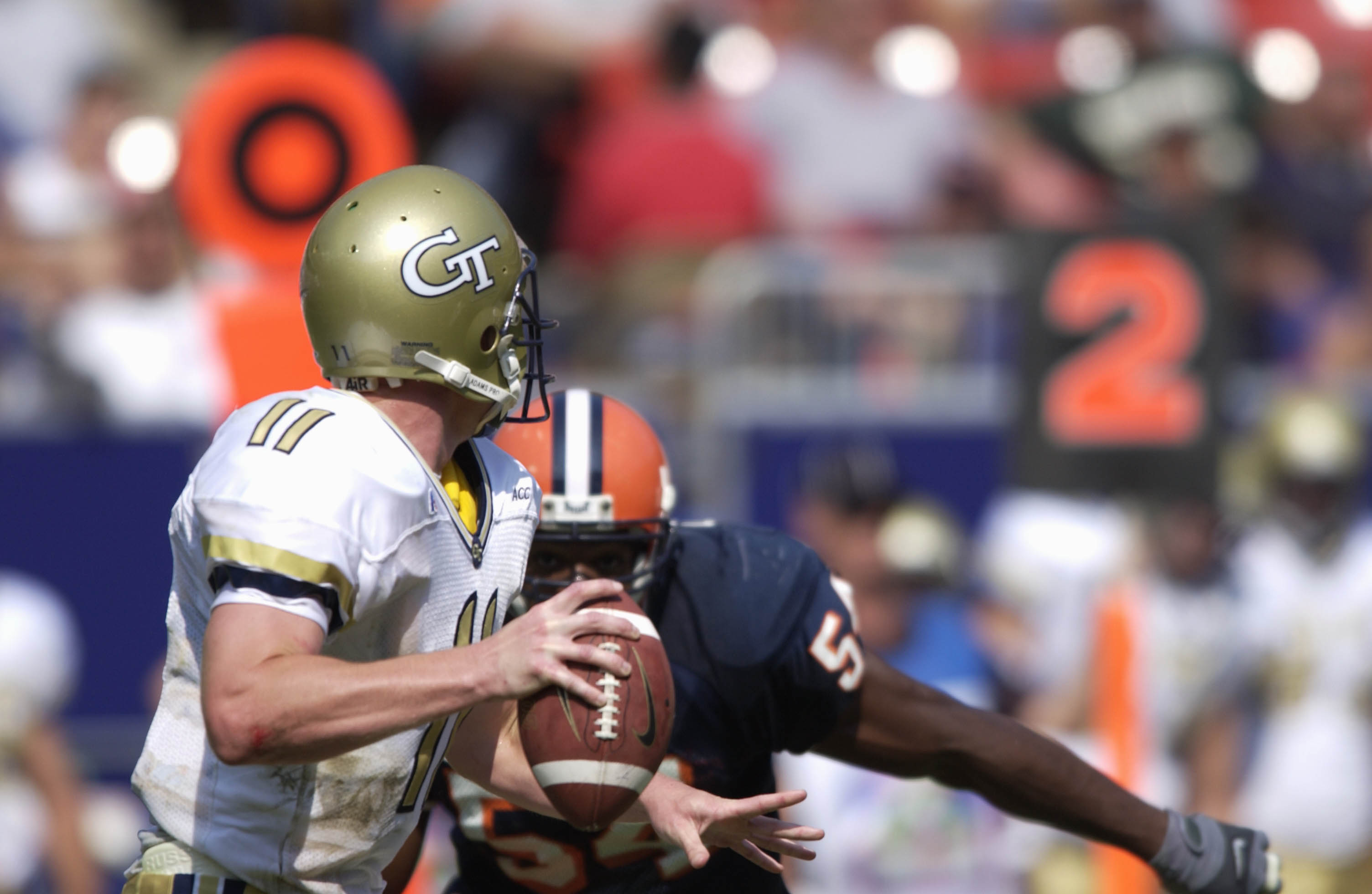 26 Aug 2001: Quarterback George Godsey #11 of Georgia Tech looks to pass as defensive end Dwight Freeney #54 closes in during the Kickoff Classic against Syracuse at Giants Stadium in East Rutherford, New Jersey.   Georgia Tech won 13-7.  DIGITAL IMAGE Ma