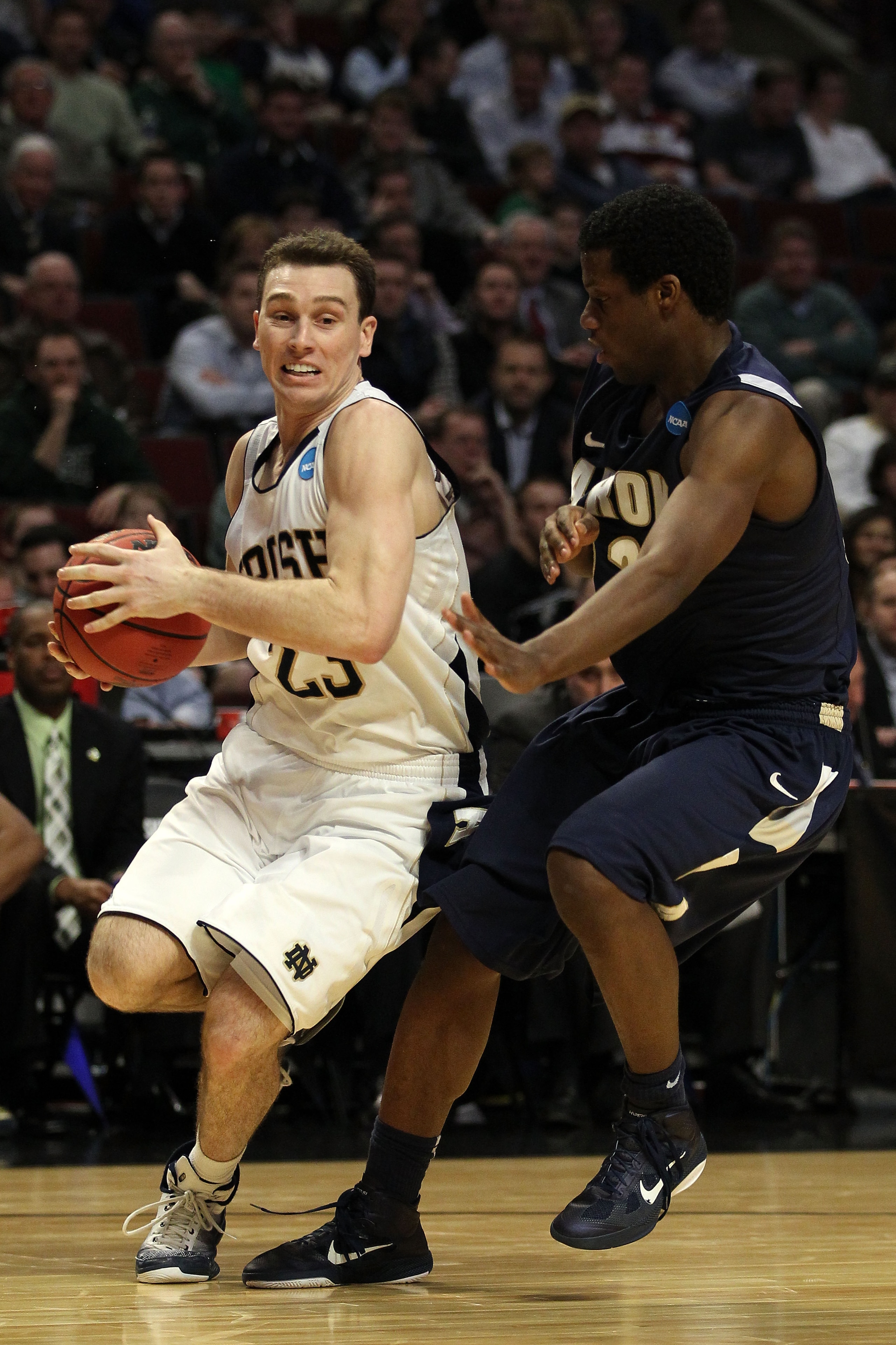 CHICAGO, IL - MARCH 18: Ben Hansbrough #23 of the Notre Dame Fighting Irish drives against Quincy Diggs #22 of the Akron Zips in the second half during the second round of the 2011 NCAA men's basketball tournament at the United Center on March 18, 2011 i CHICAGO, IL - MARCH 18: Ben Hansbrough #23 of the Notre Dame Fighting Irish drives against Quincy Diggs #22 of the Akron Zips in the second half during the second round of the 2011 NCAA men's basketball tournament at the United Center on March 18, 2011 i