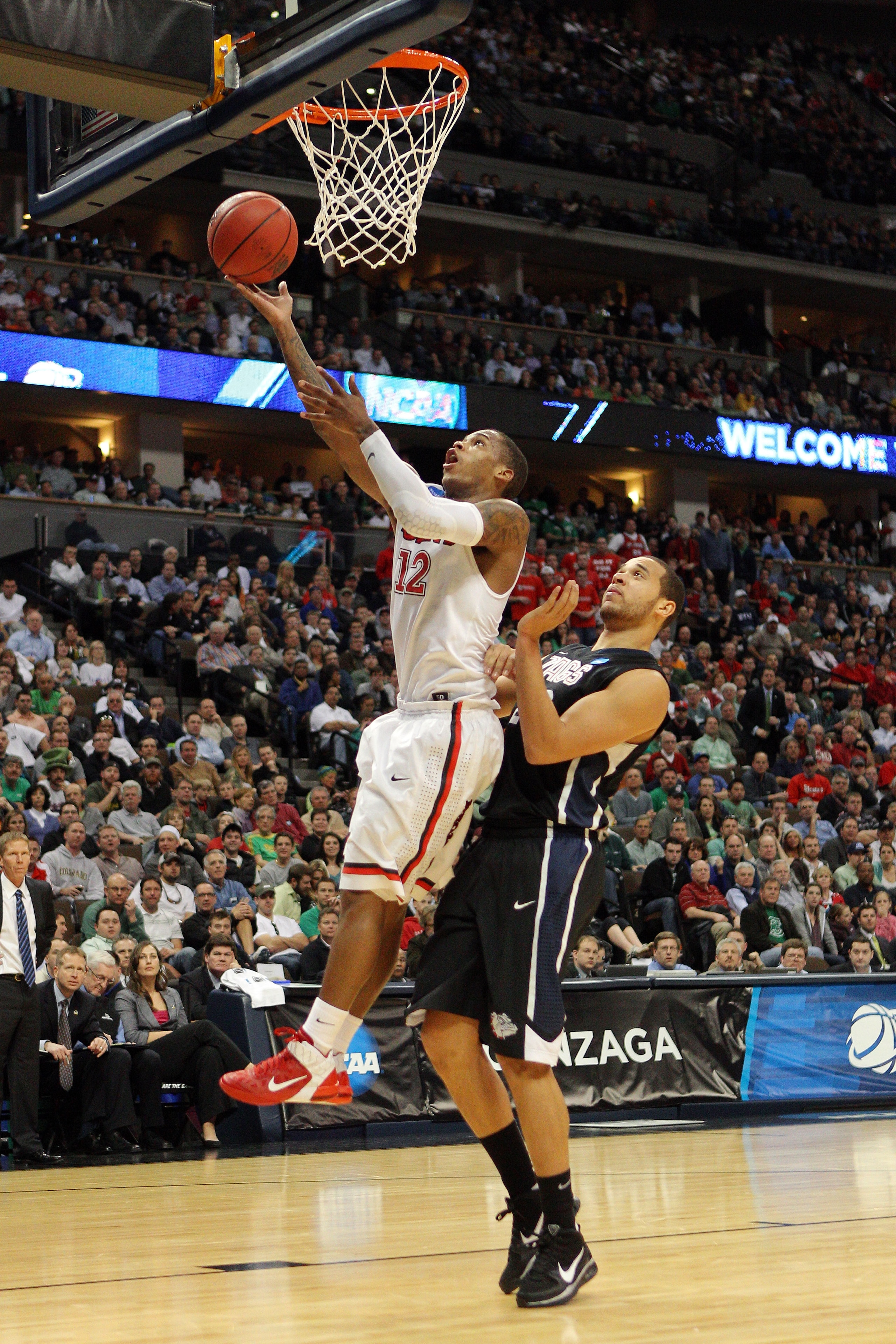 DENVER, CO - MARCH 17: Dwight Hardy #12 of the St. John's Red Storm goes to the hoop against Elias Harris #20 of the Gonzaga Bulldogs during the second round of the 2011 NCAA men's basketball tournament at Pepsi Center on March 17, 2011 in Denver, Colora DENVER, CO - MARCH 17: Dwight Hardy #12 of the St. John's Red Storm goes to the hoop against Elias Harris #20 of the Gonzaga Bulldogs during the second round of the 2011 NCAA men's basketball tournament at Pepsi Center on March 17, 2011 in Denver, Colora