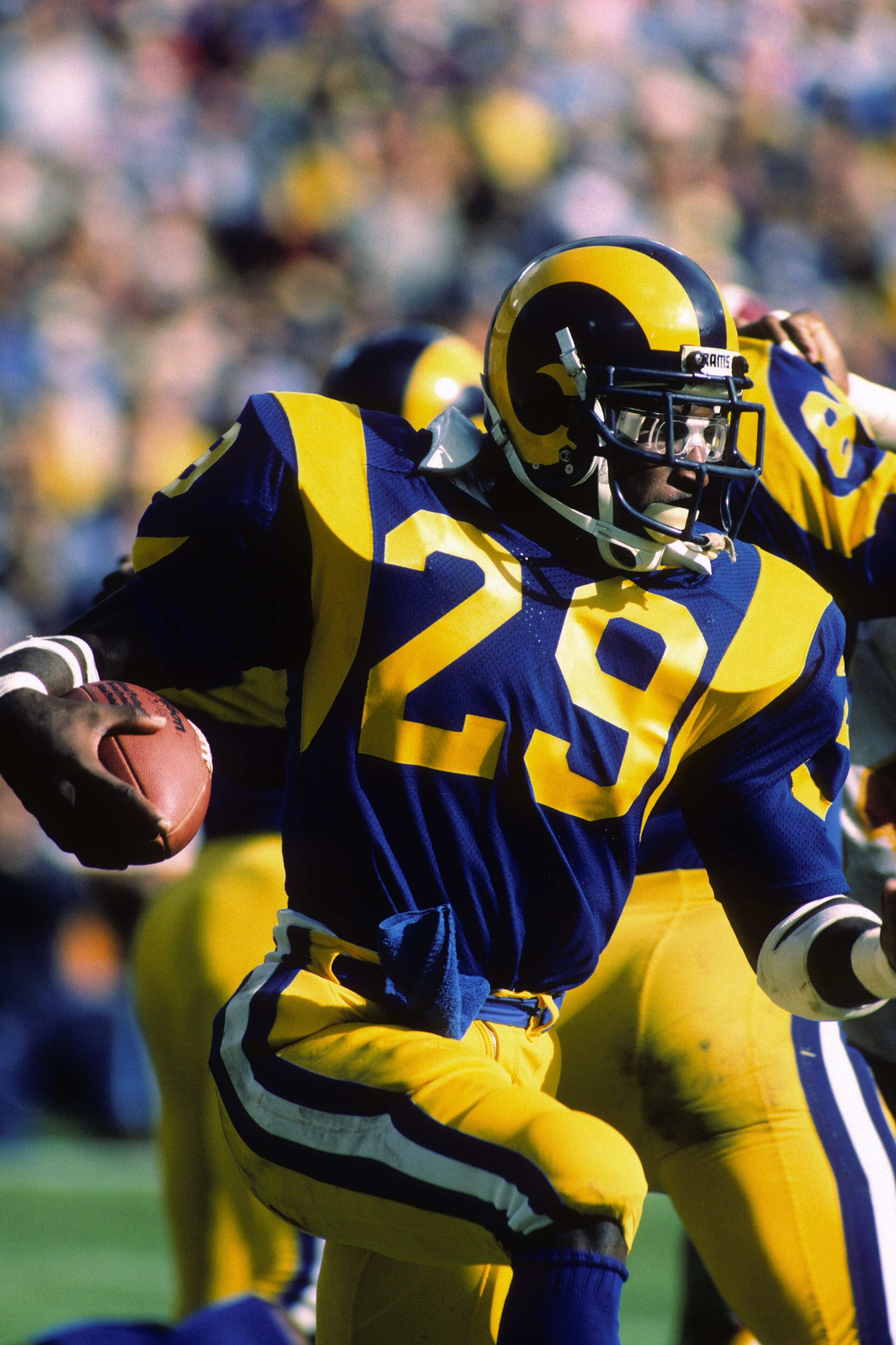 ANAHEIM, CA - NOVEMBER 20:  Running back Eric Dickerson #29 of the Los Angeles Rams looks for room to run against the Washington Redskins during the game at Anaheim Stadium on November 20, 1983 in Anaheim, California.  The Redskins won 42-20.  (Photo by G