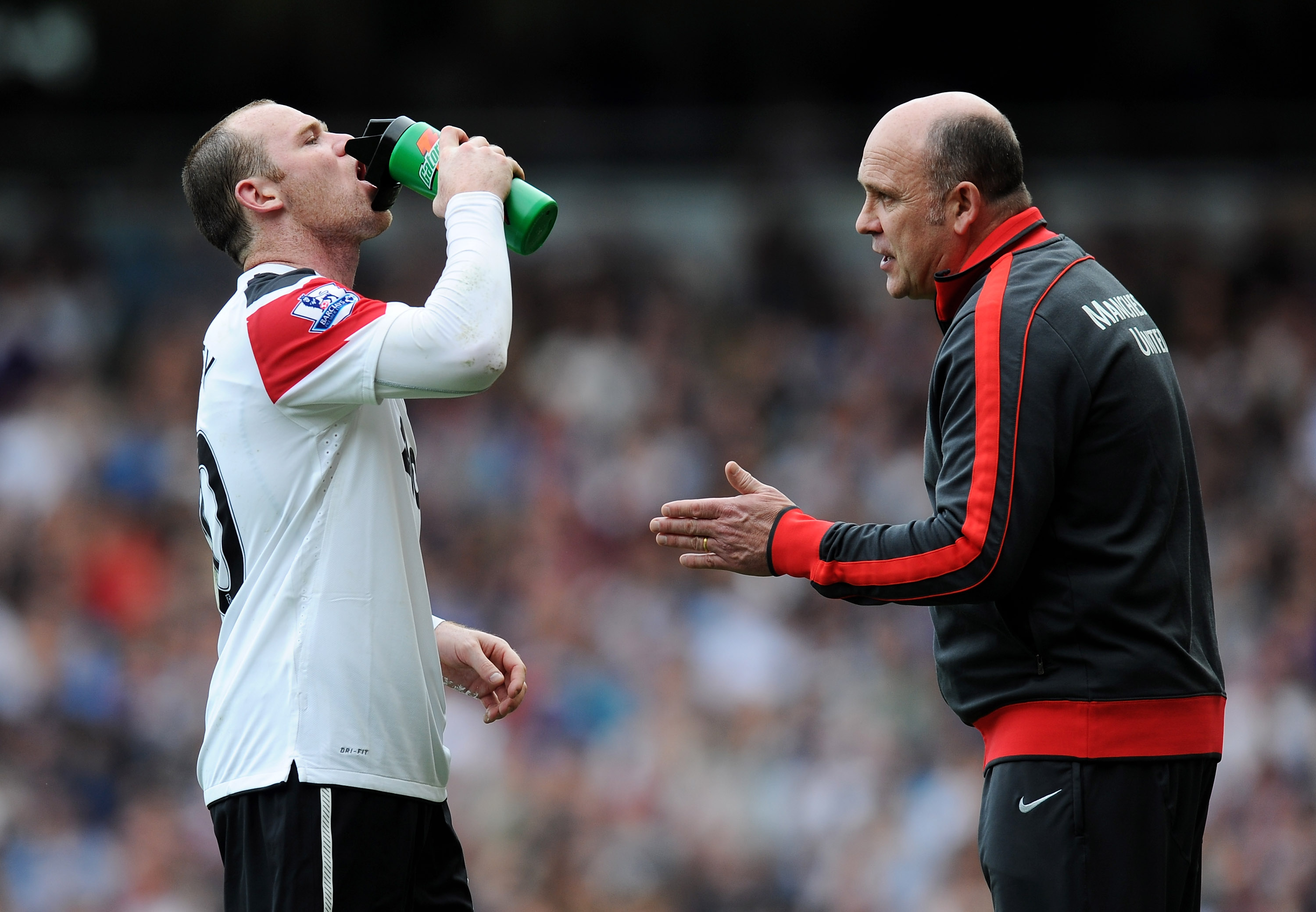 LONDON, ENGLAND - APRIL 02:  Manchester United assistant Mike Phelan talks to Wayne Rooney during the Barclays Premier League match between West Ham United and Manchester United at the Boleyn Ground on April 2, 2011 in London, England.  (Photo by Mike Hew
