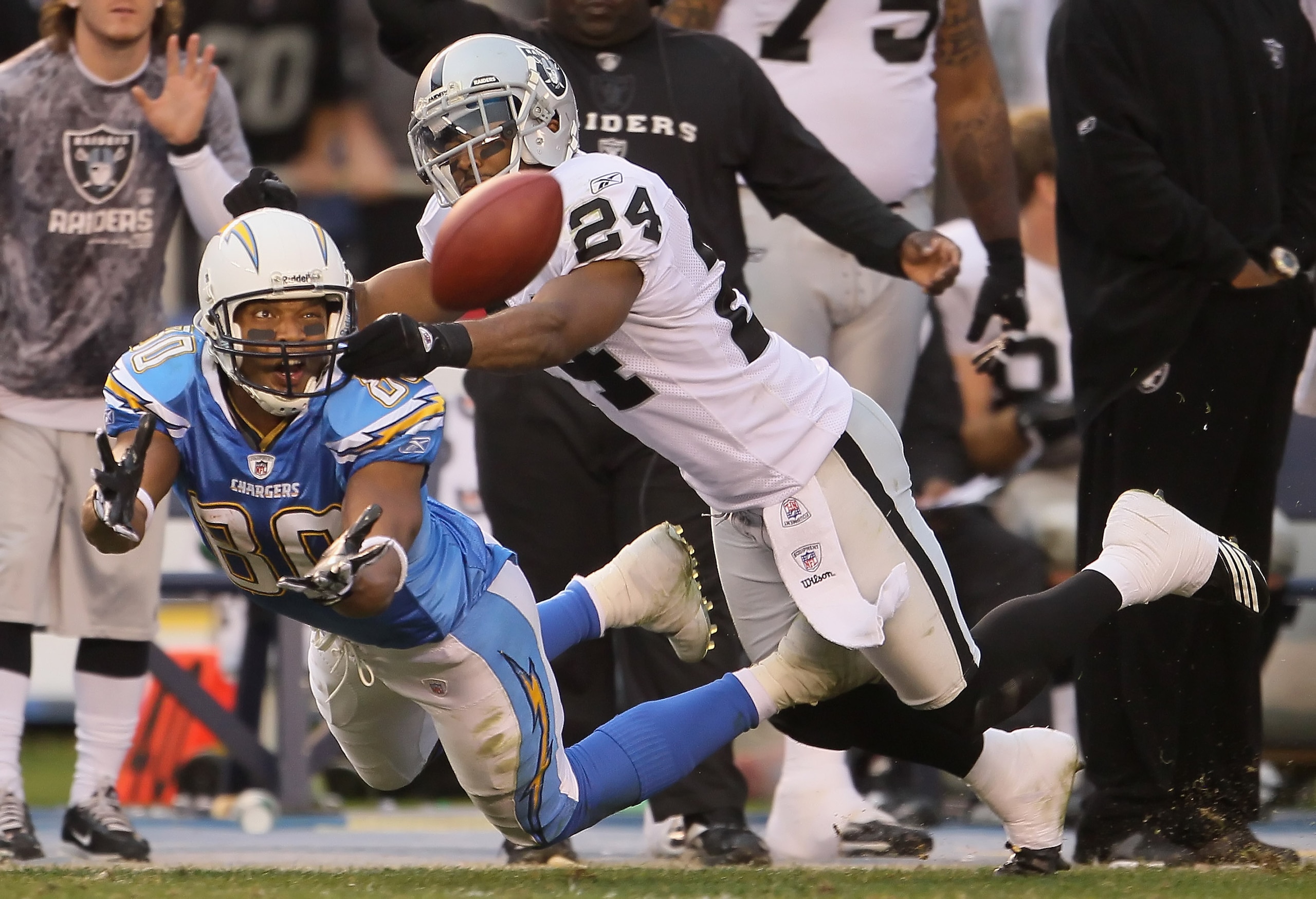 SAN DIEGO - DECEMBER 05:  Michael Huff #24 of the Oakland Raiders breaks up a pass intended for wide receiver Malcolm Floyd #80 of the San Diego Chargers at Qualcomm Stadium on December 5, 2010 in San Diego, California. The Raiders defeated the Chargers 2