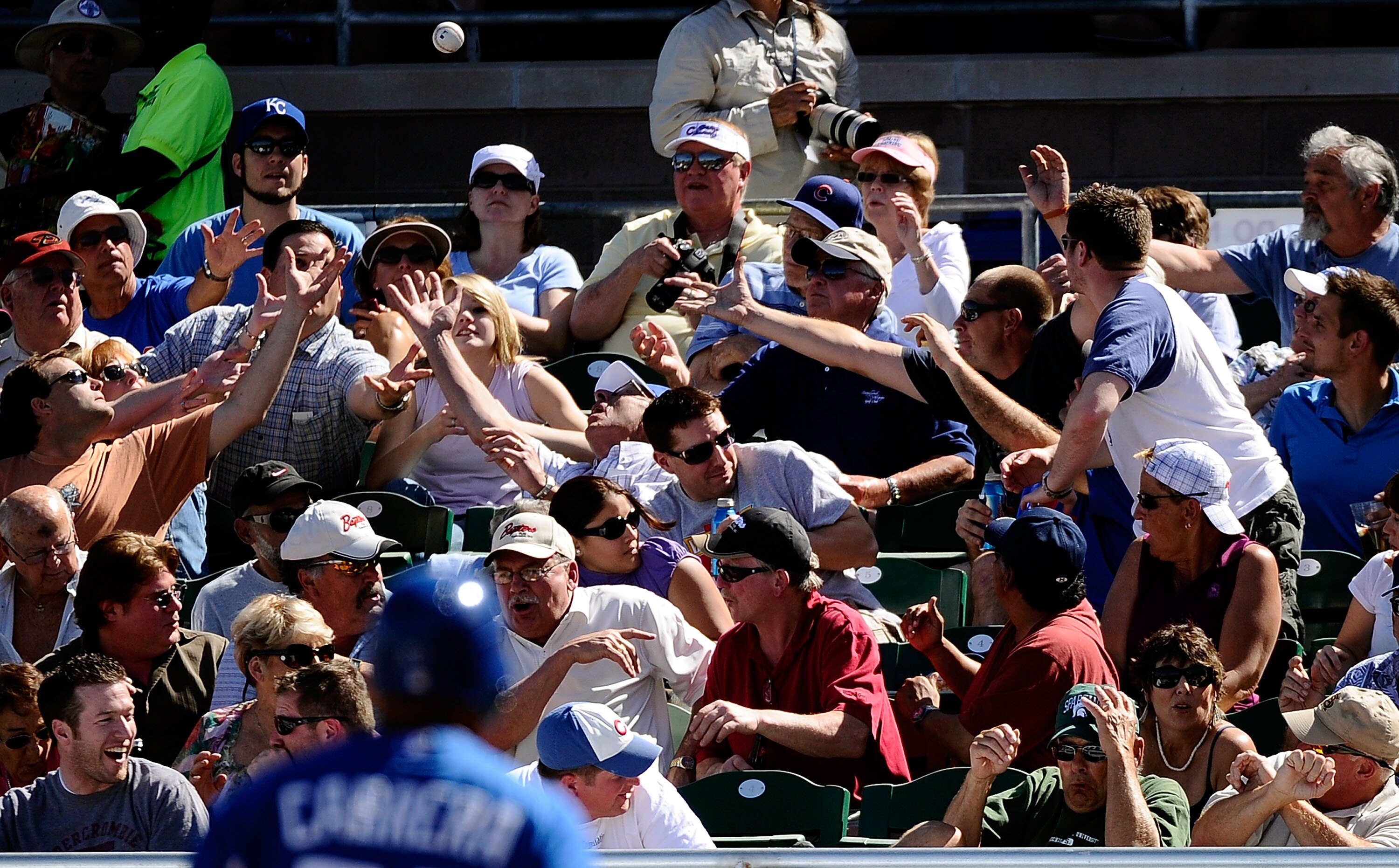 MESA, AZ - MARCH 09:  Fan catch a foul ball in the game between the Chicago Cubs and the Kansas City Royals at HoHoKam Stadium on March 9, 2011 in Mesa, Arizona.  (Photo by Kevork Djansezian/Getty Images)