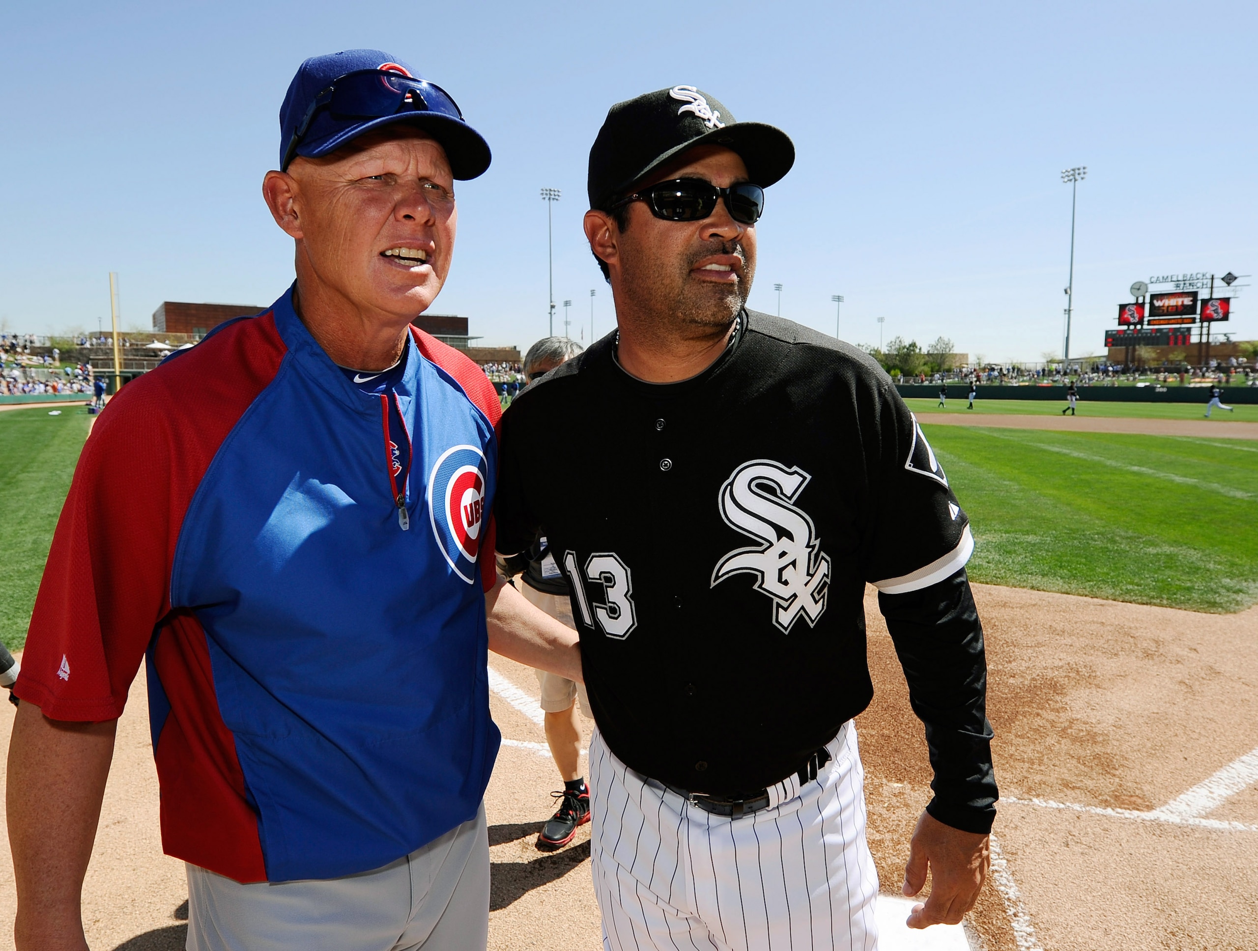 GLENDALE, AZ - MARCH 11:  Managers Mike Quade #8 of the Chicago Cubs and Ozzie Guillen #13 of the Chicago White Sox greet each other at home plate prior to the start of the spring training baseball game at Camelback Ranch on March 11, 2011 in Glendale, Ar