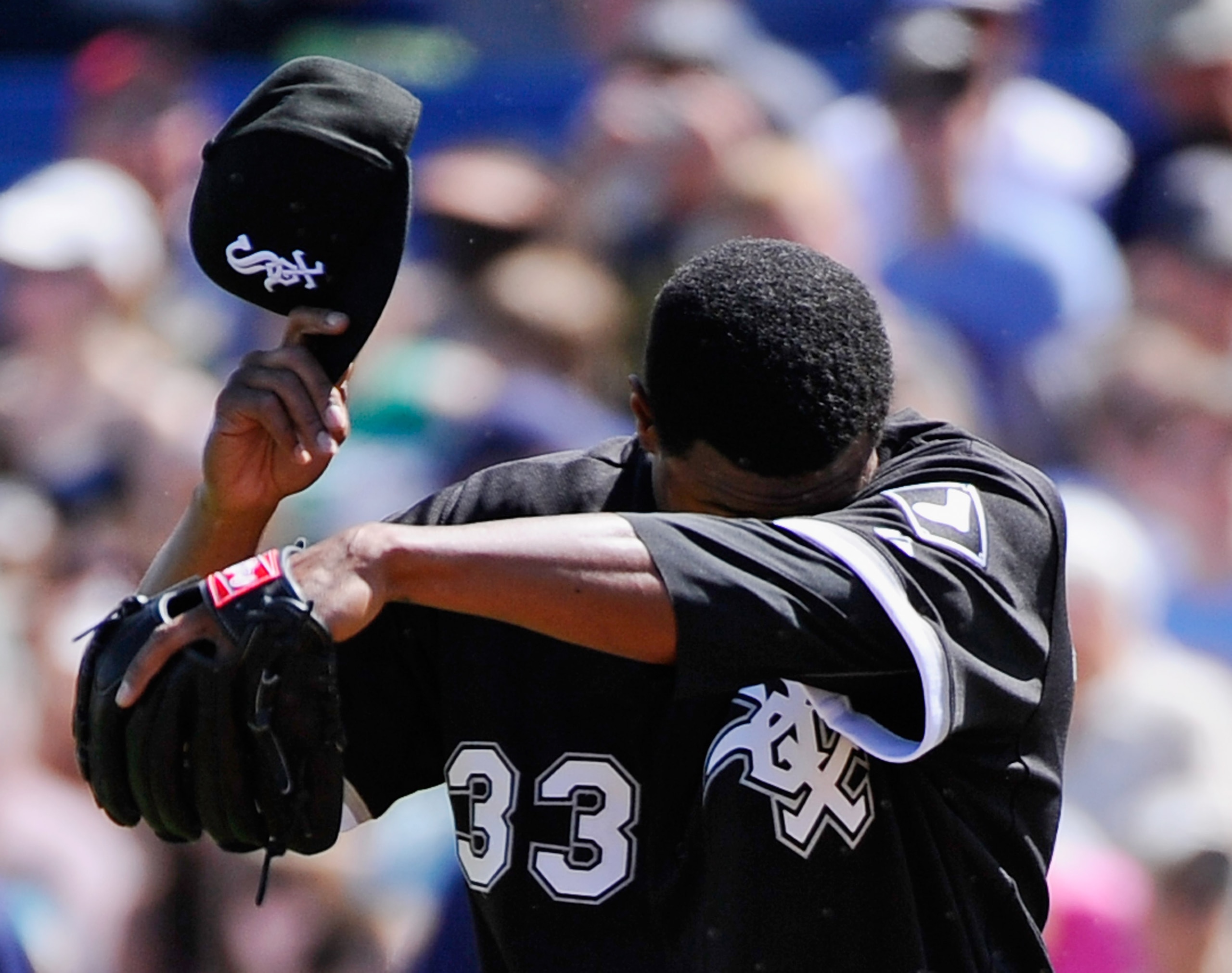 PHOENIX, AZ - MARCH 17:  Pitcher Edwin Jackson #33 of the Chicago White Sox wipes his face after giving up a basehit to Prince Fielder #28 of the Milwaukee Brewers during the first inning of the spring training game at Maryvale Baseball Park on March 17,